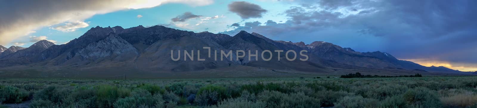 Mountain range with clouded colorful sunset, Eastern Sierra Nevada Mountains, Mono County, California, USA.