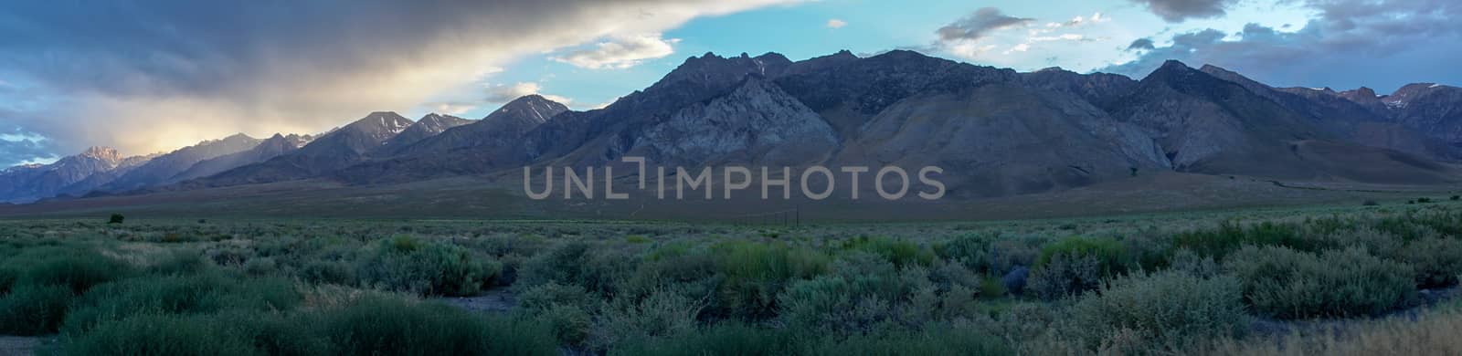 Mountain range with clouded colorful sunset, Eastern Sierra Nevada Mountains, Mono County, California, USA.