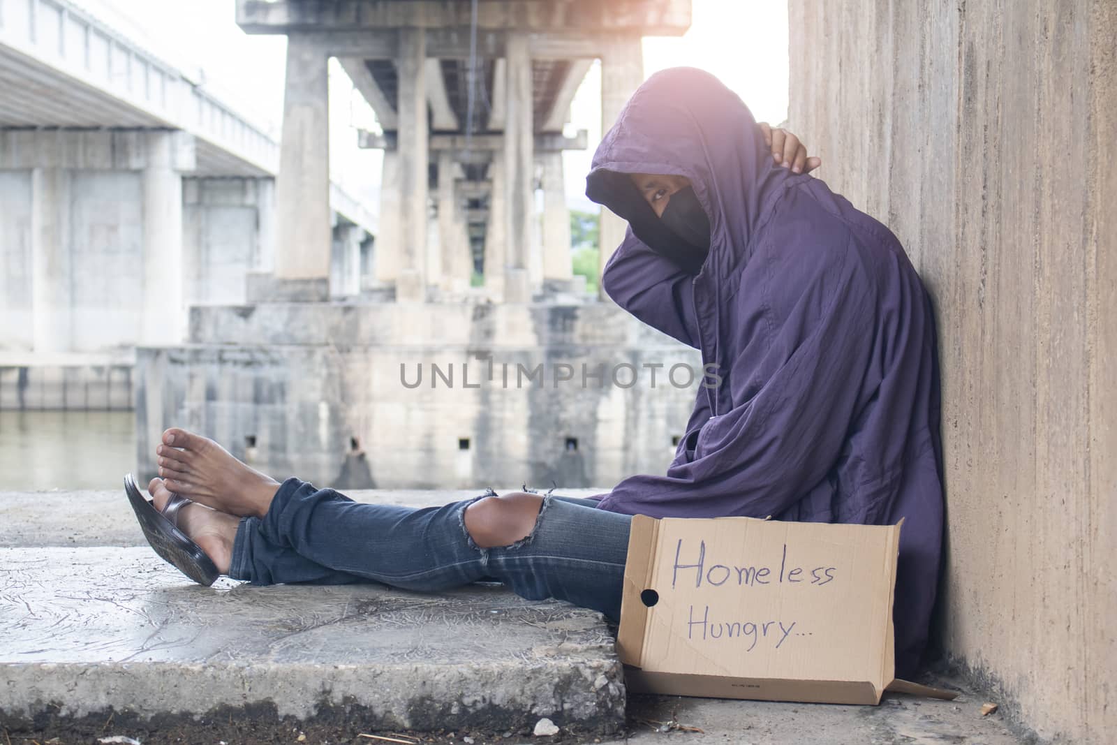 Unhappy homeless man under the bridge