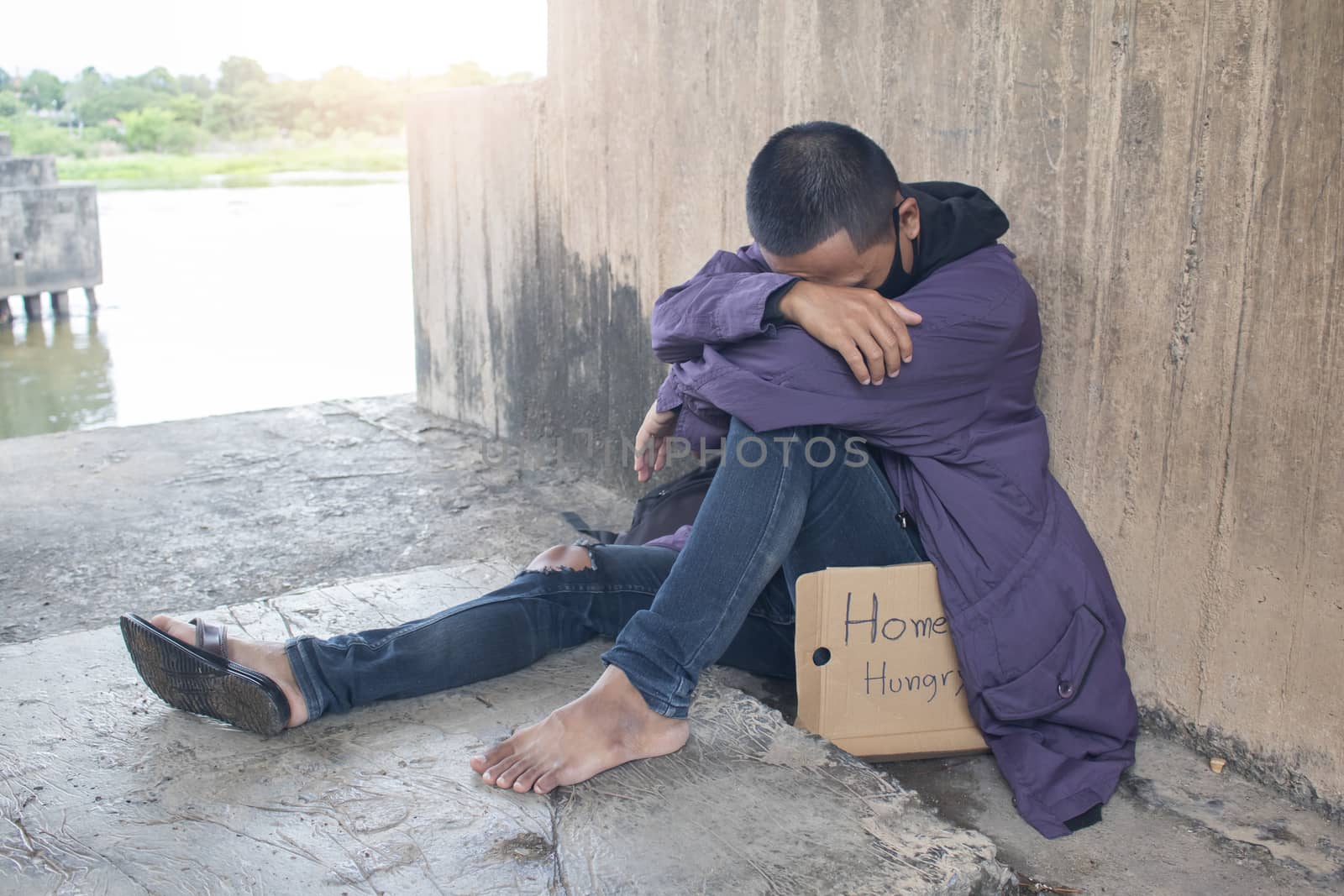 Unhappy homeless man under the bridge