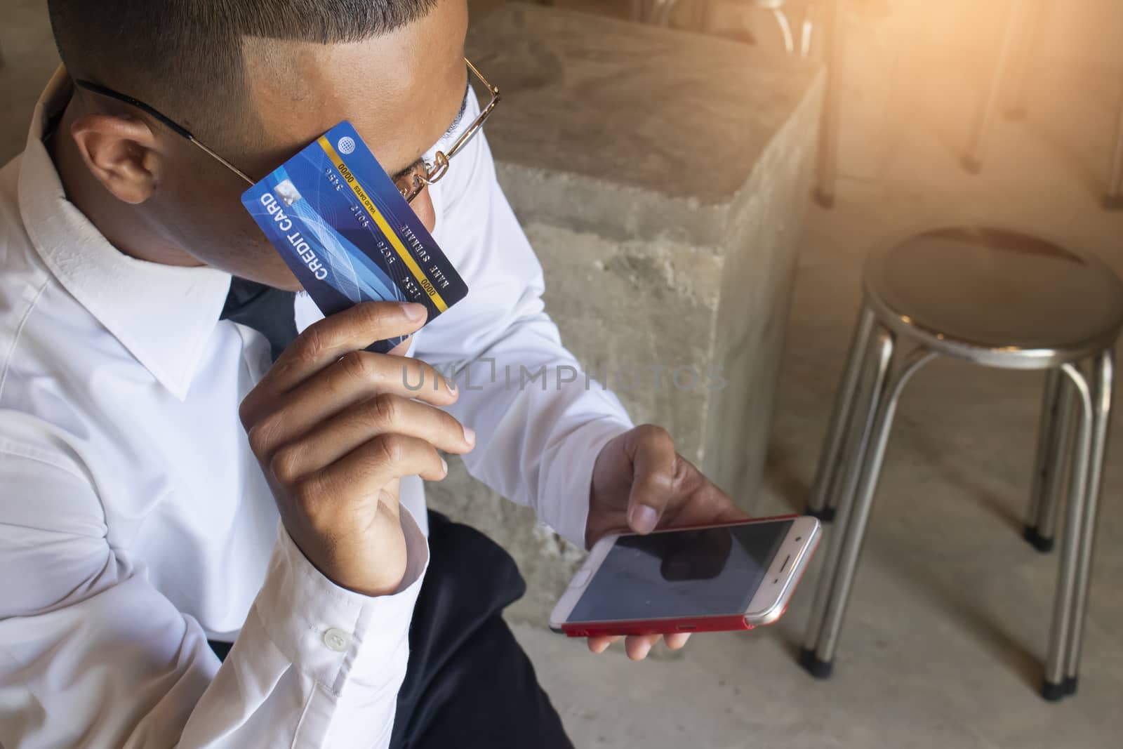 Asian business man using cradit card for shopping online with smart phone