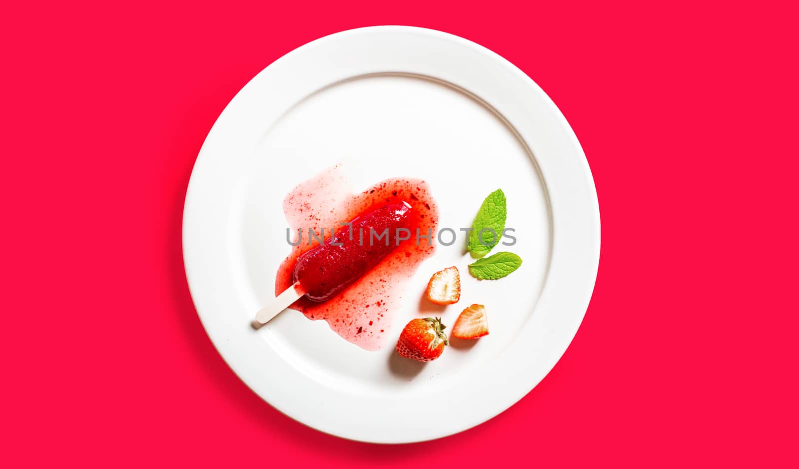 Delicious strawberry popsicles on light background