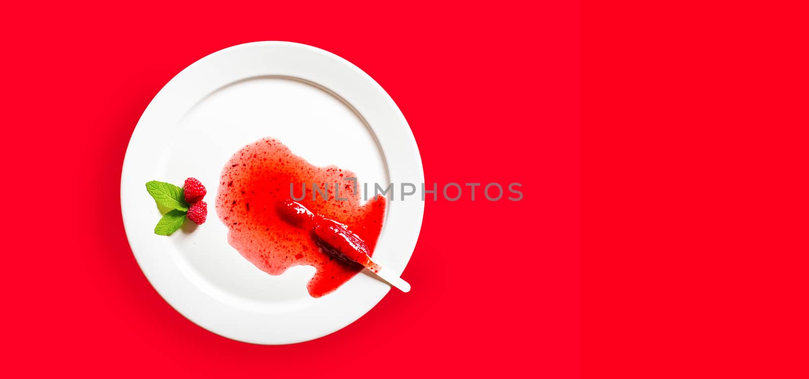 Delicious defrosted strawberry popsicles on white round dish over red background by raferto1973