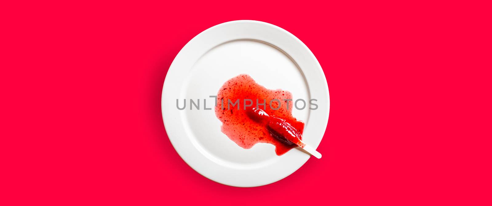 Delicious defrosted strawberry popsicles on white round dish over red background by raferto1973