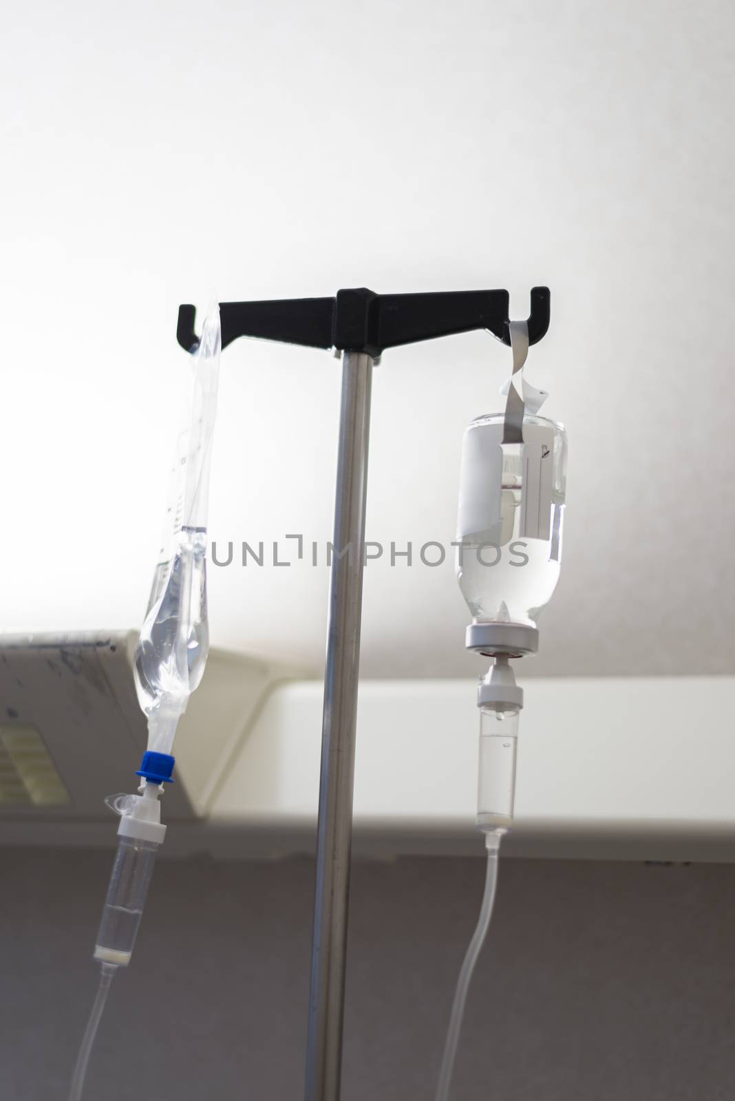 Dark image of a IV drip bags in a hospital room.