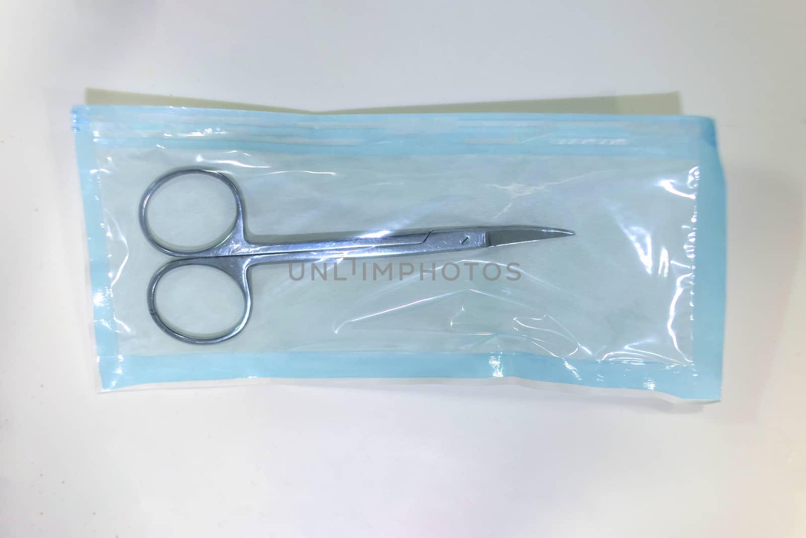 Medical scissors inside a sterilized blister ready for use it.