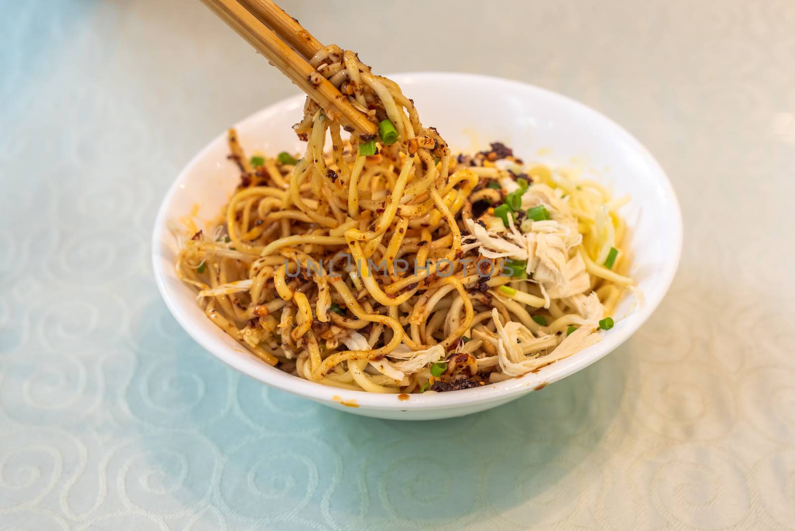 LiangMian cold noodles chinese dish with chopsticks close-up view