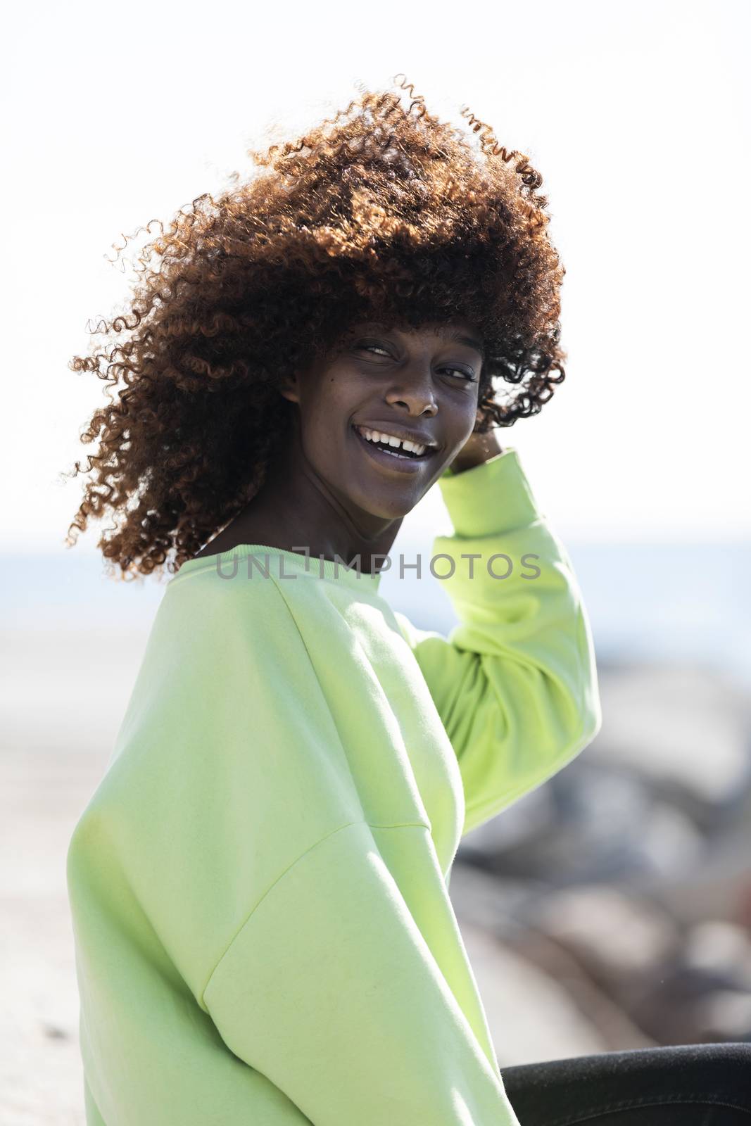 Portrait of a beautiful afro american woman standing in the street in a sunny day by raferto1973