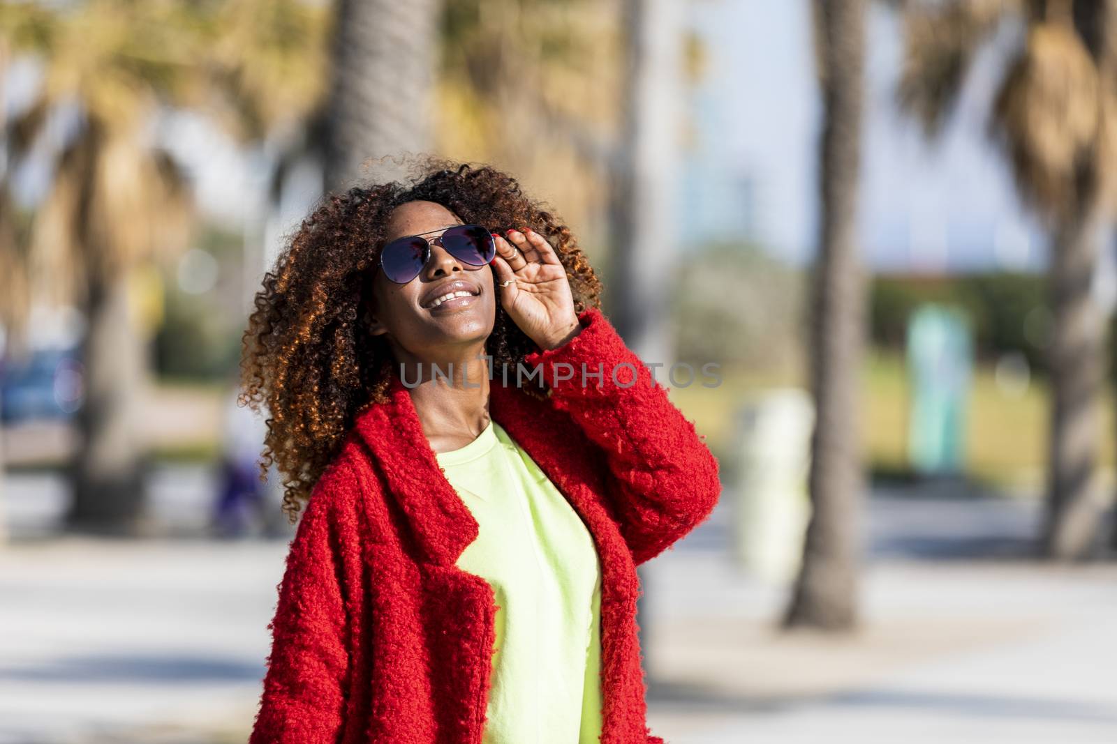 Portrait of a beautiful afro american woman standing in the street in a sunny day