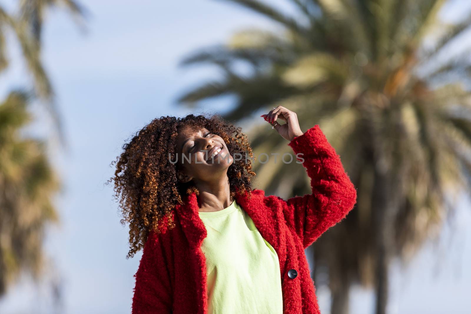 Portrait of a beautiful afro american woman standing in the street in a sunny day