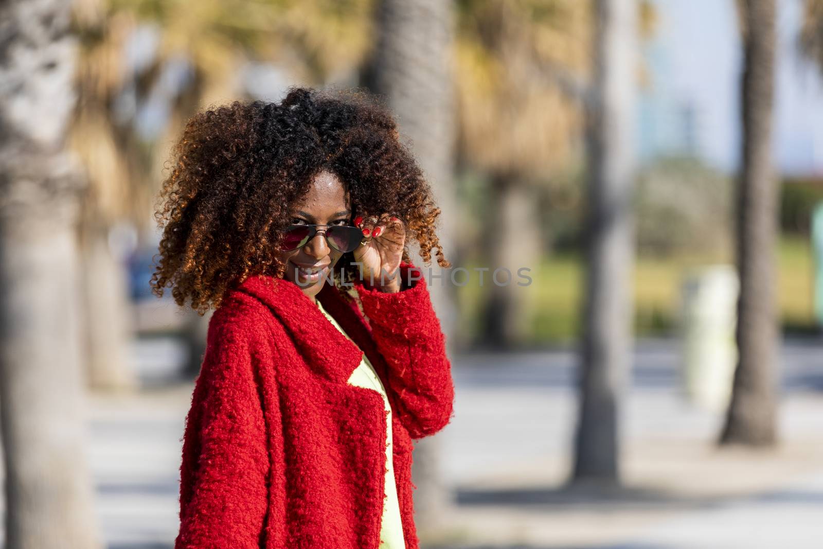 Portrait of a beautiful afro american woman standing in the street in a sunny day