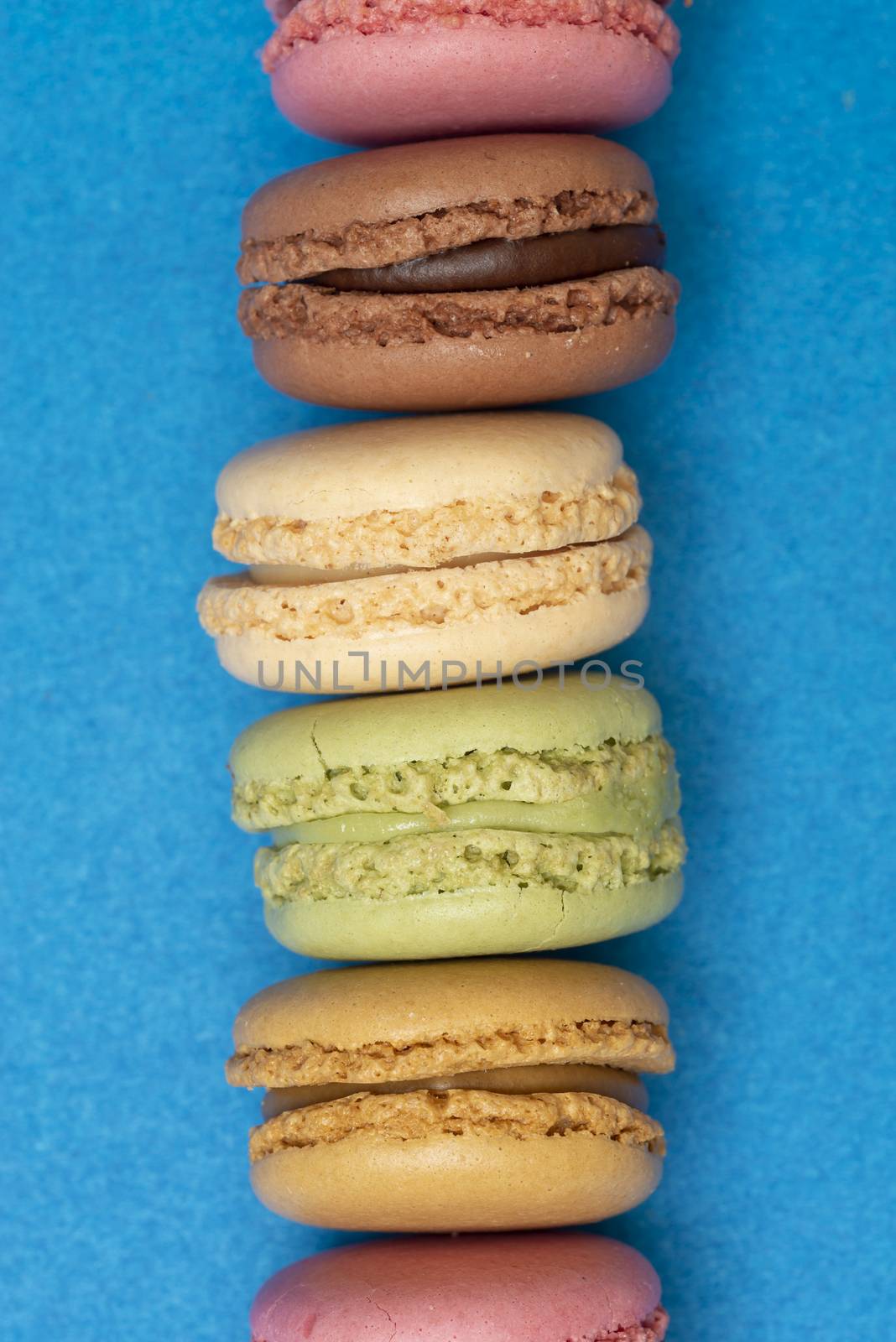 Colorful macaroons over a colored bakcground