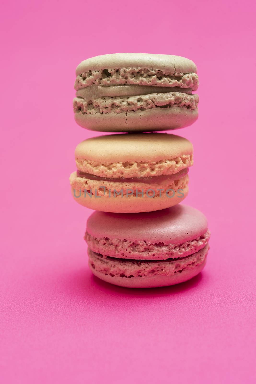 Colorful macaroons over a pink bakcground