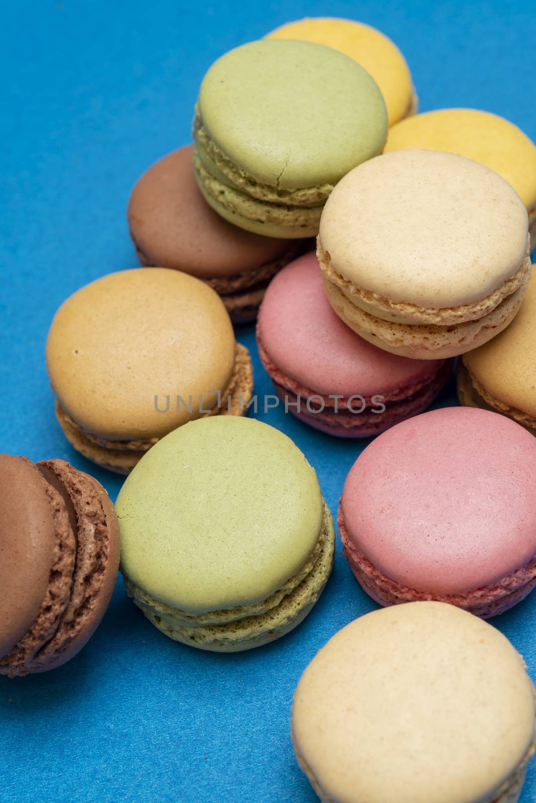 Colorful macaroons over a colored bakcground