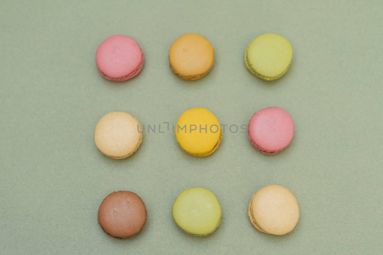 Macaroons on green background from above