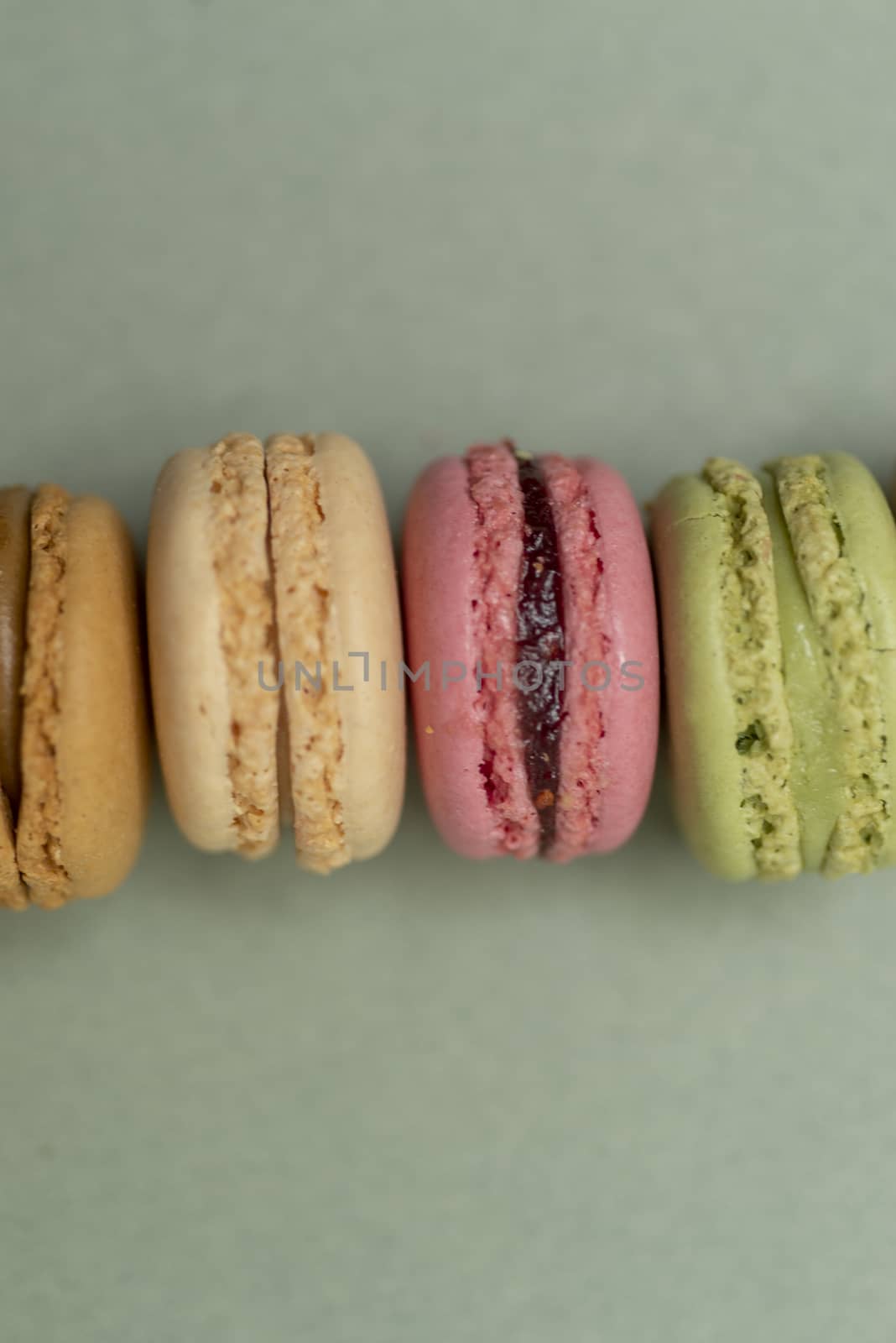 Macaroons on green background from above