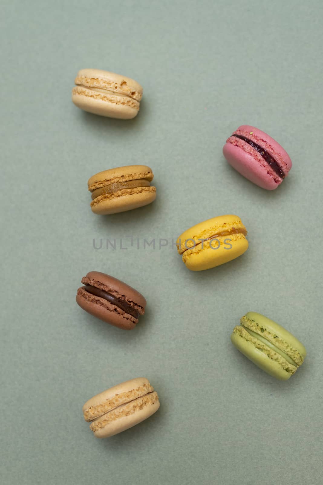 Macaroons on green background from above