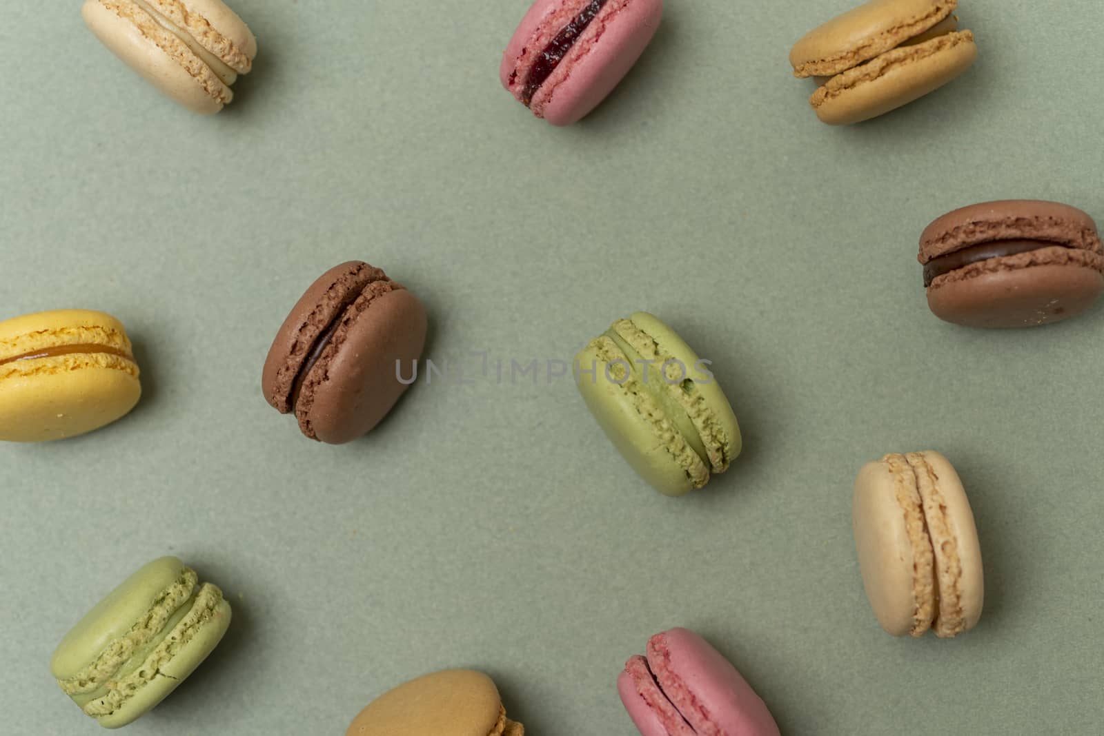 Macaroons on green background from above