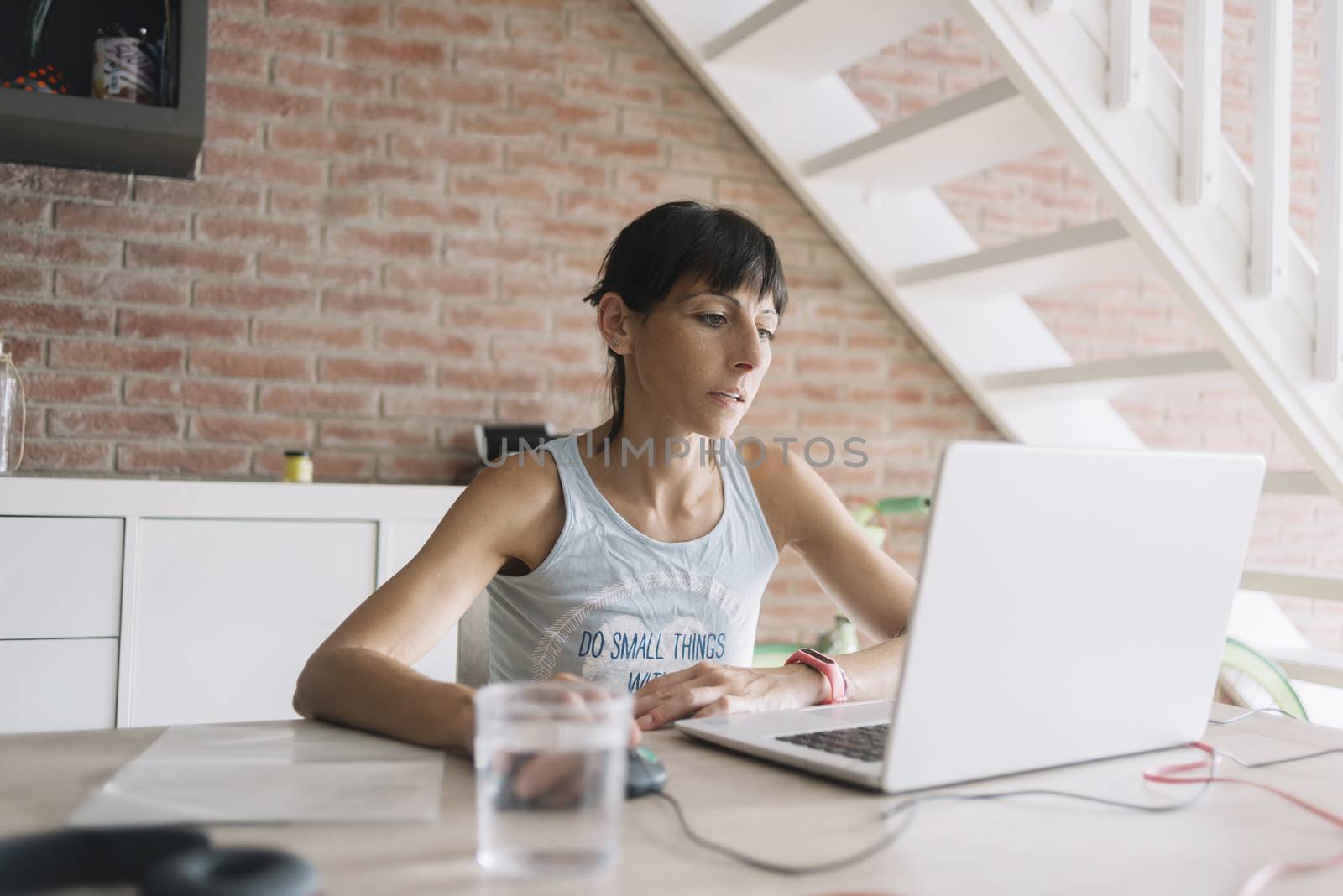 Woman with laptop working at home