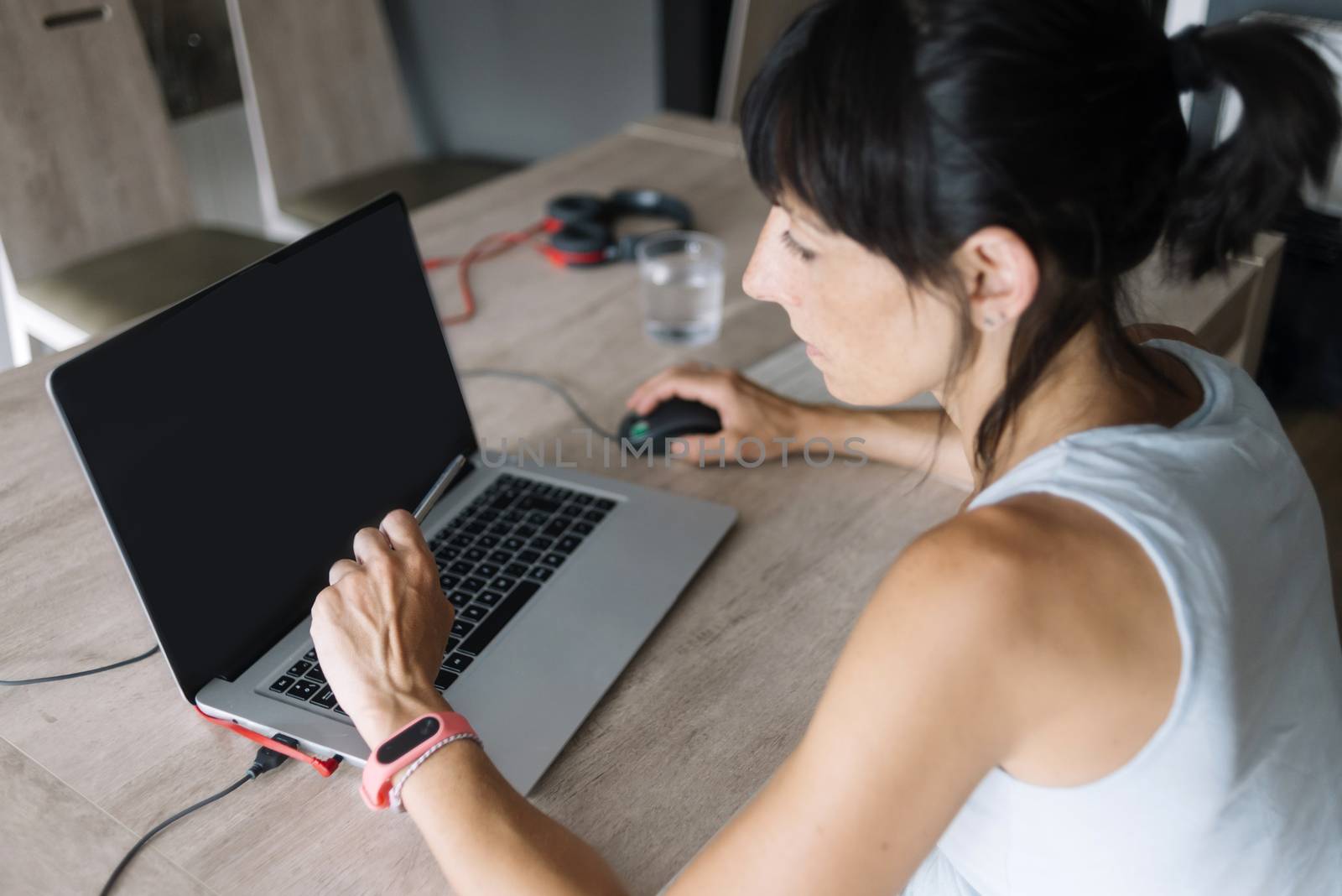 Woman with laptop working at home