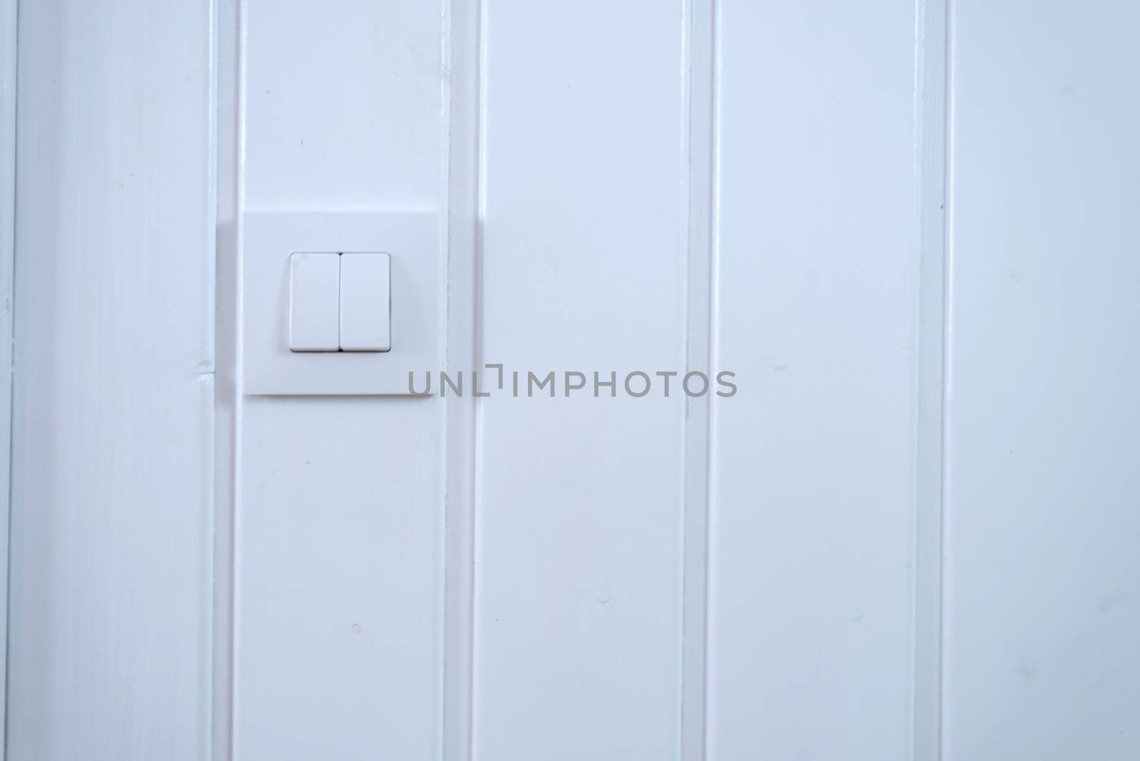 Light switch Two Switches On over a white wall by raferto1973