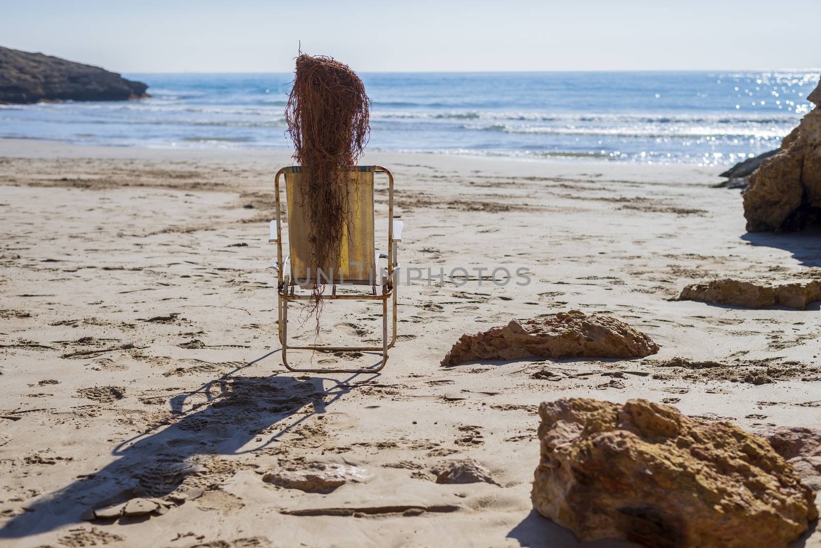 Side view of Trunk doll on beach chair simulating a person sunbathing