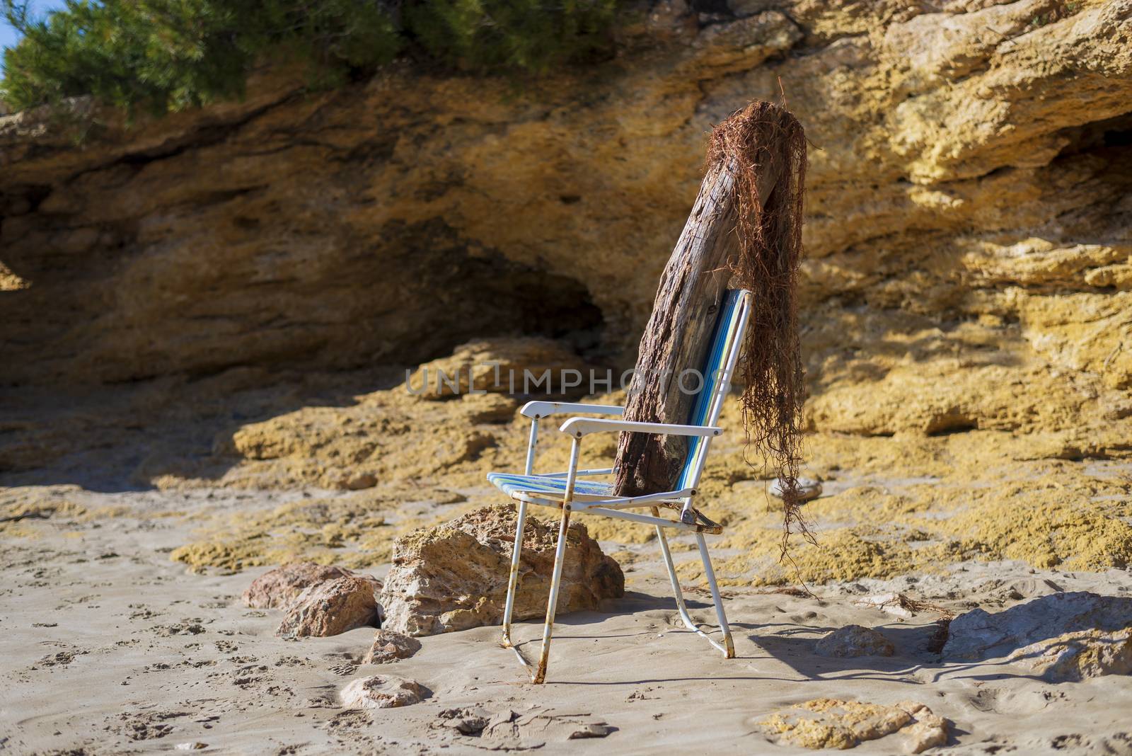 Trunk doll on beach chair simulating a person sunbathing