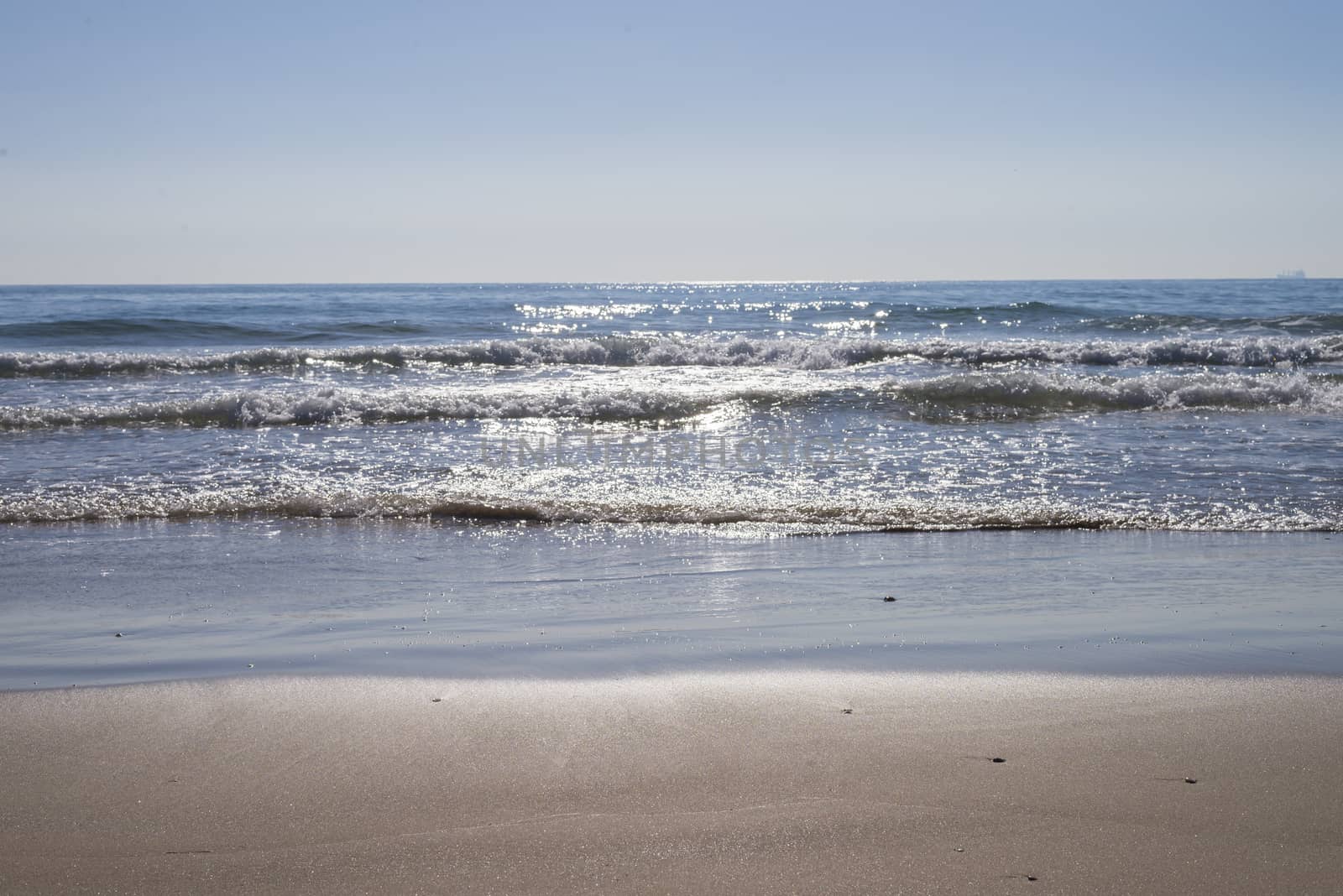 View from seashore of waves on surface of the sea