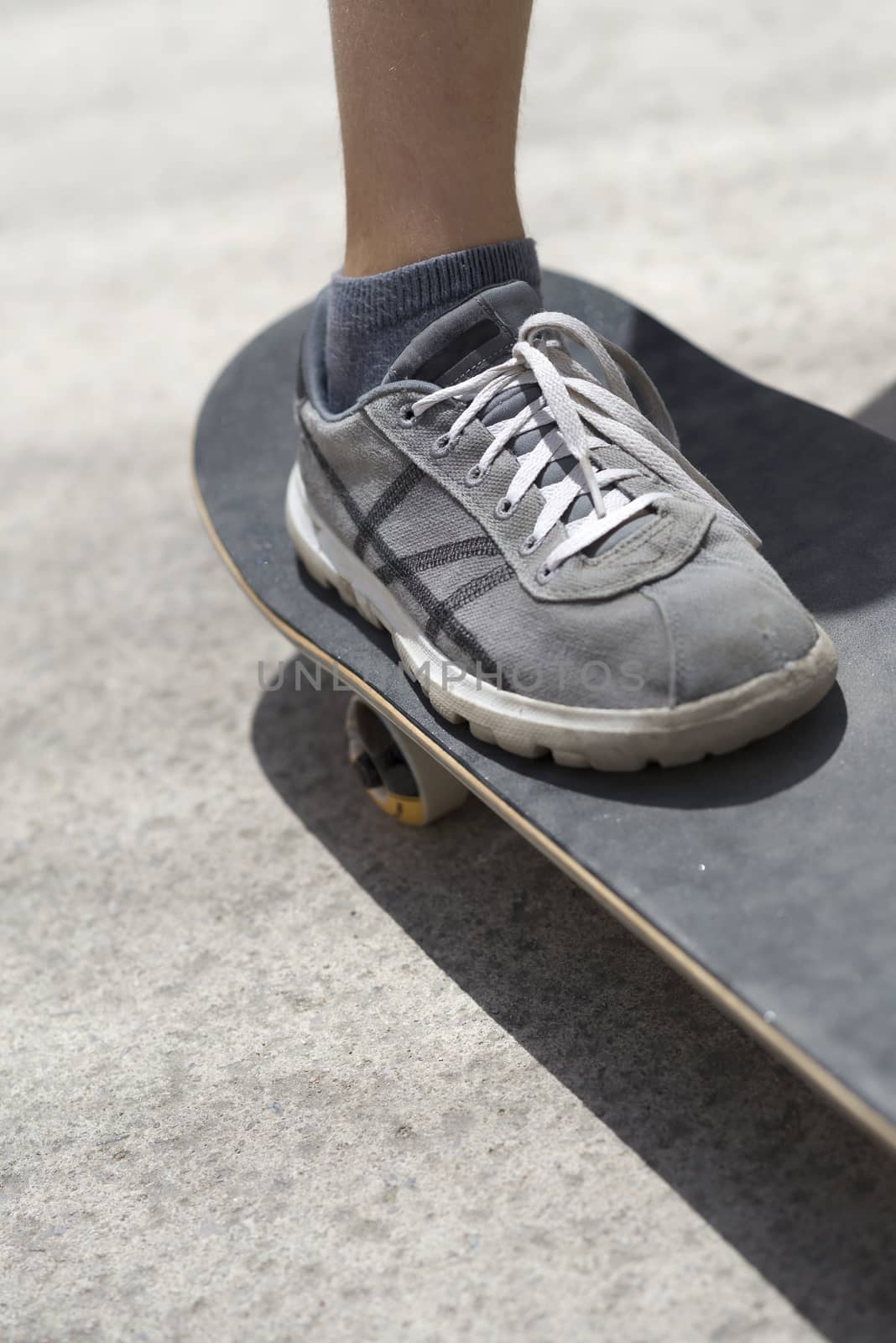 Close up of a young skateboarder shoe riding on skateboard by raferto1973