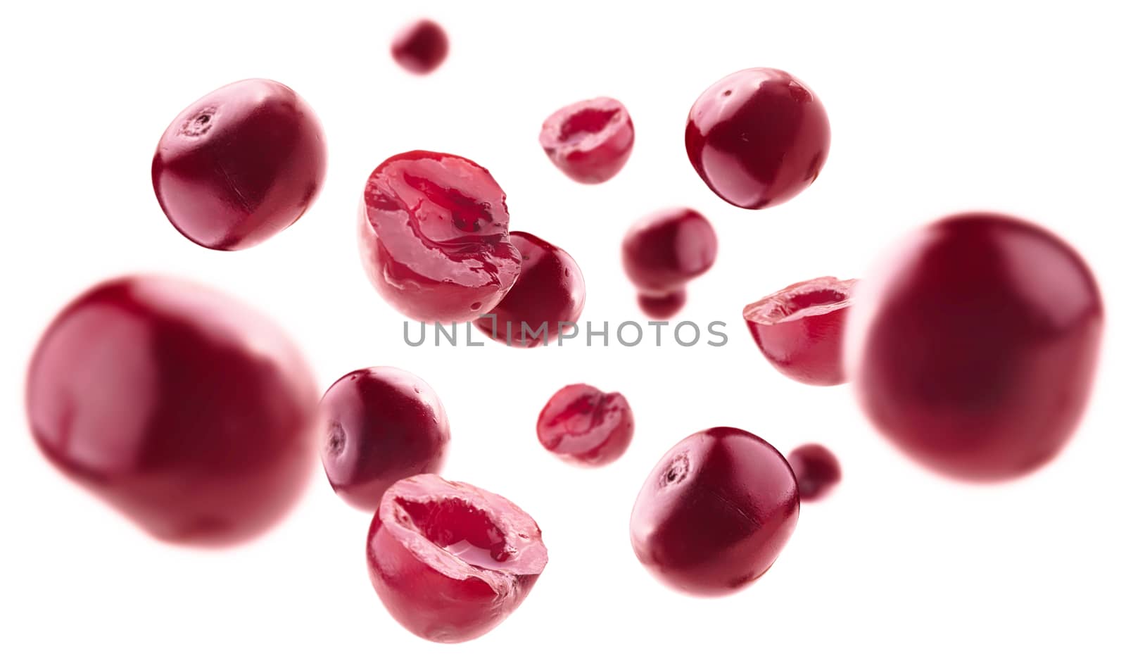Red cherry berries levitate on a white background.