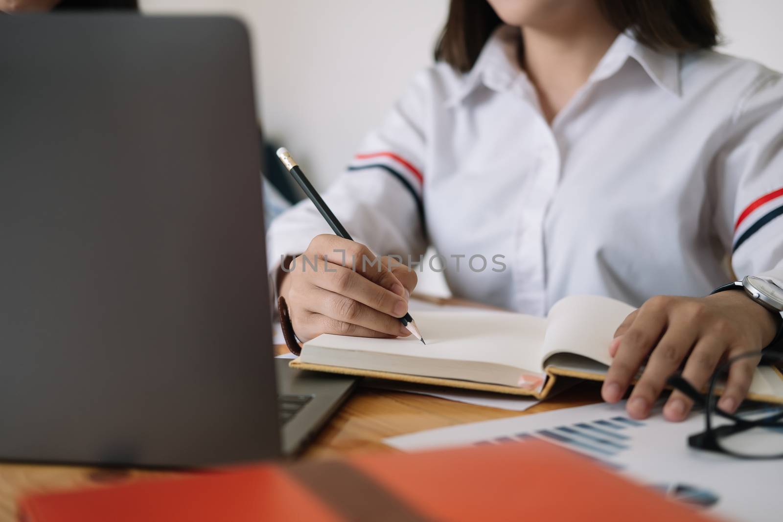 Student using computer laptop for training online and writing lecture note. e-learning education concept.