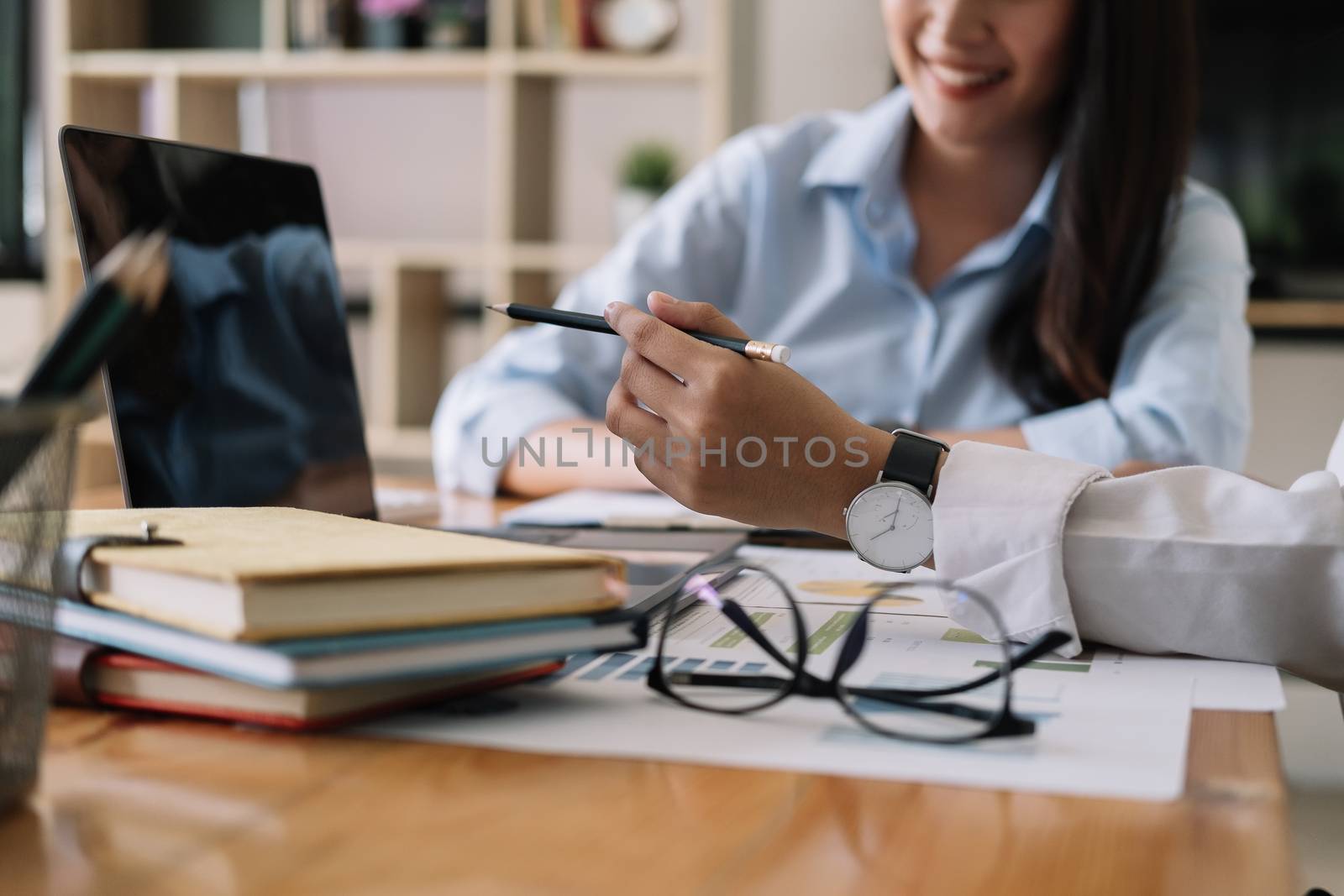 Asian business adviser meeting to analyze and discuss the situation on the financial report in the meeting room. Financial advisor and accounting concept.