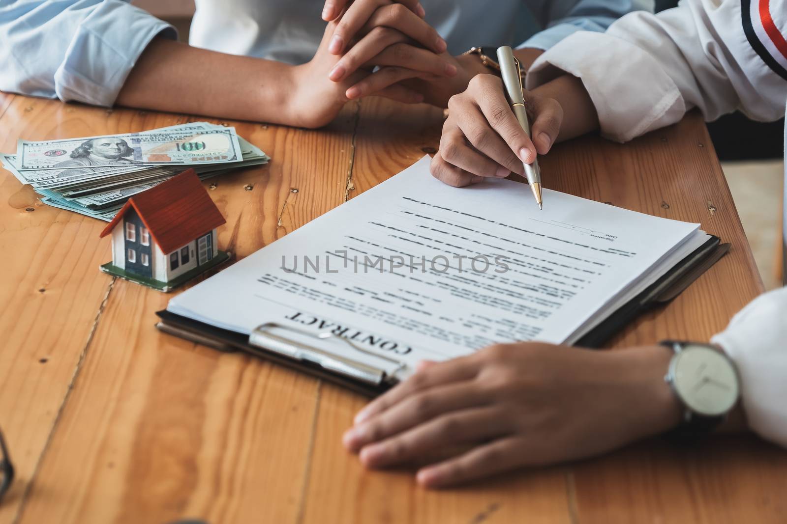 Real estate agents agree to buy a home and give keys to clients at their agency's offices. Concept agreement.