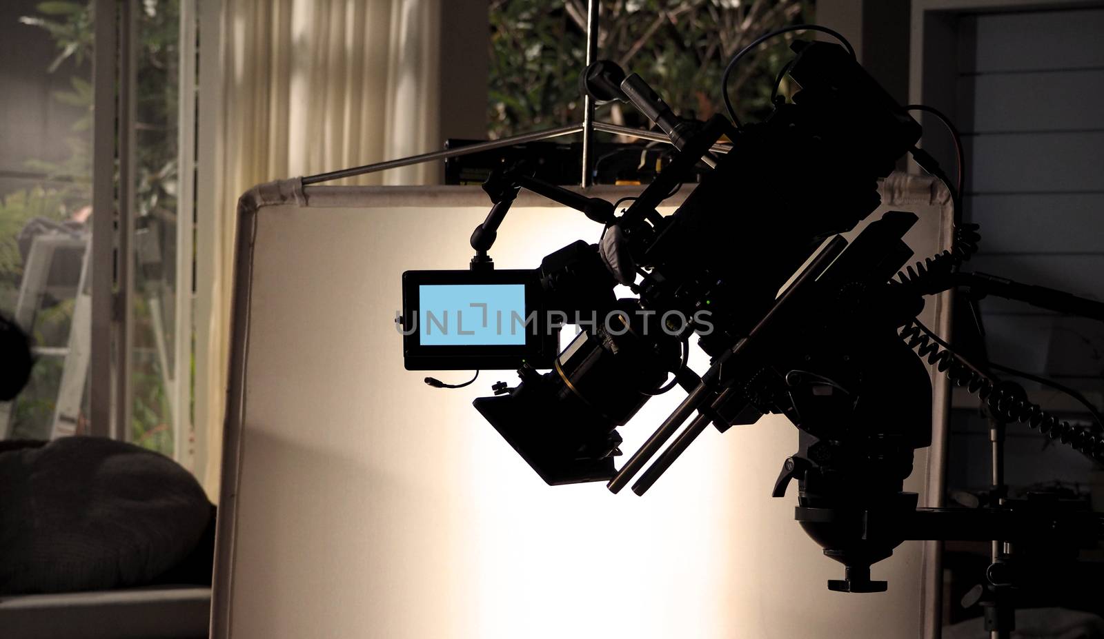 Silhouette images of video camera in tv commercial studio produc by gnepphoto