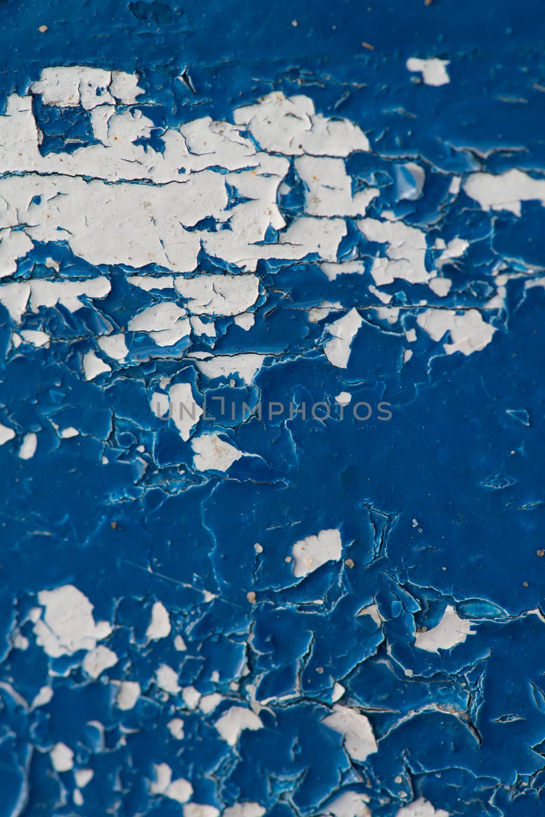 peeling blue paint close up on wood showing texture and pattern
