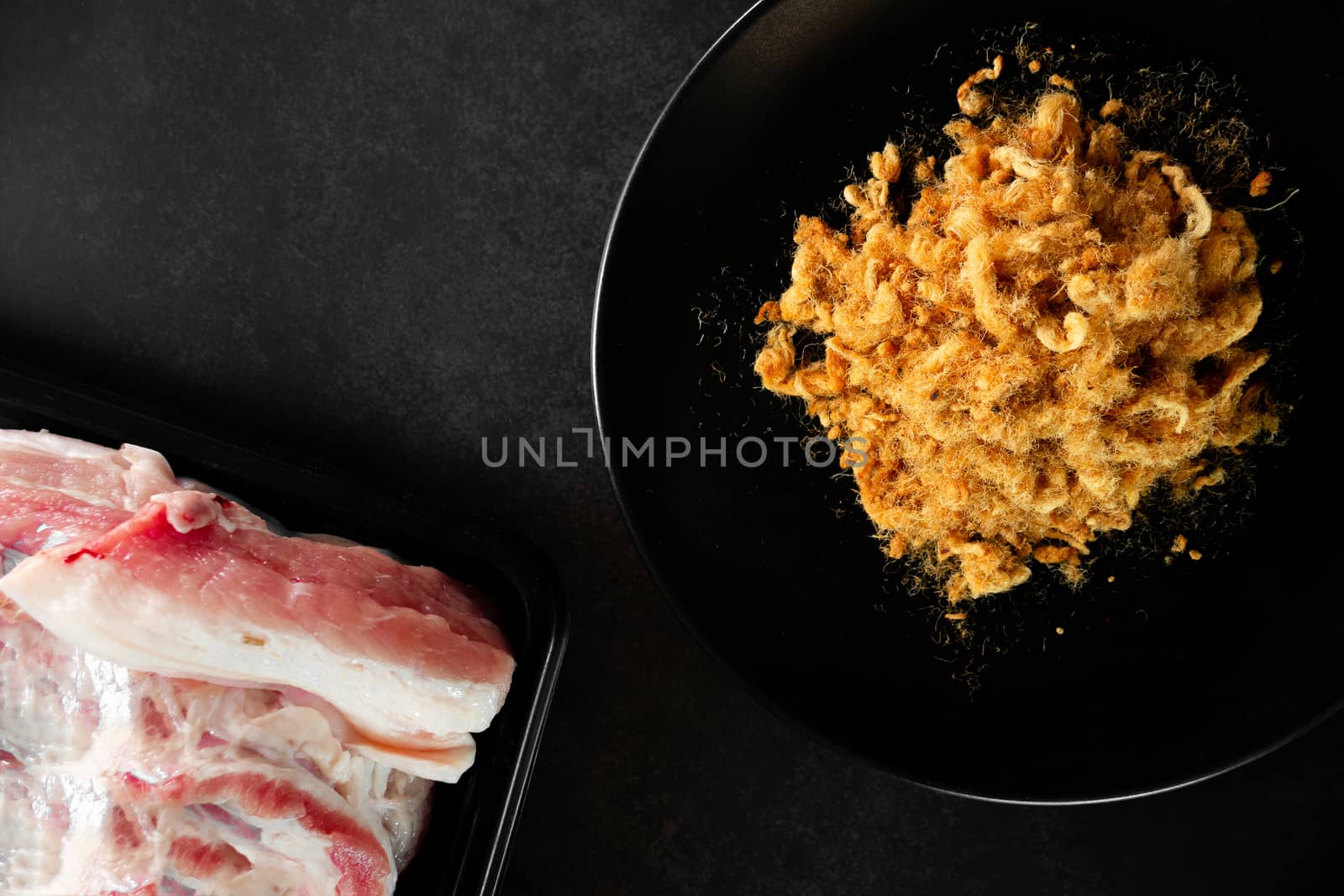 Dried shredded pork on black background, Flossy pork, Raw material, Top view