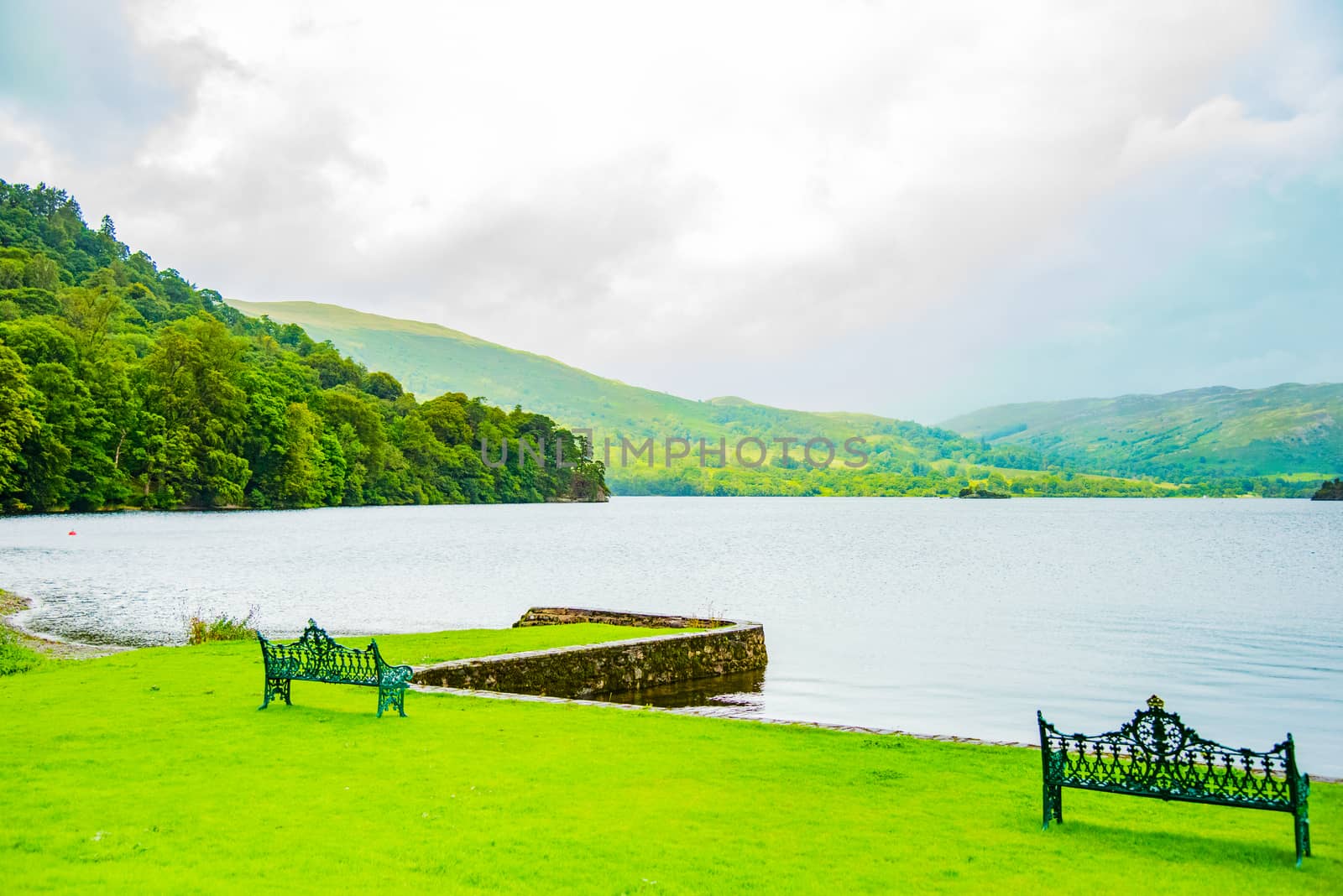 Empty benches on the shore of lake ullswater with beautiful view by paddythegolfer