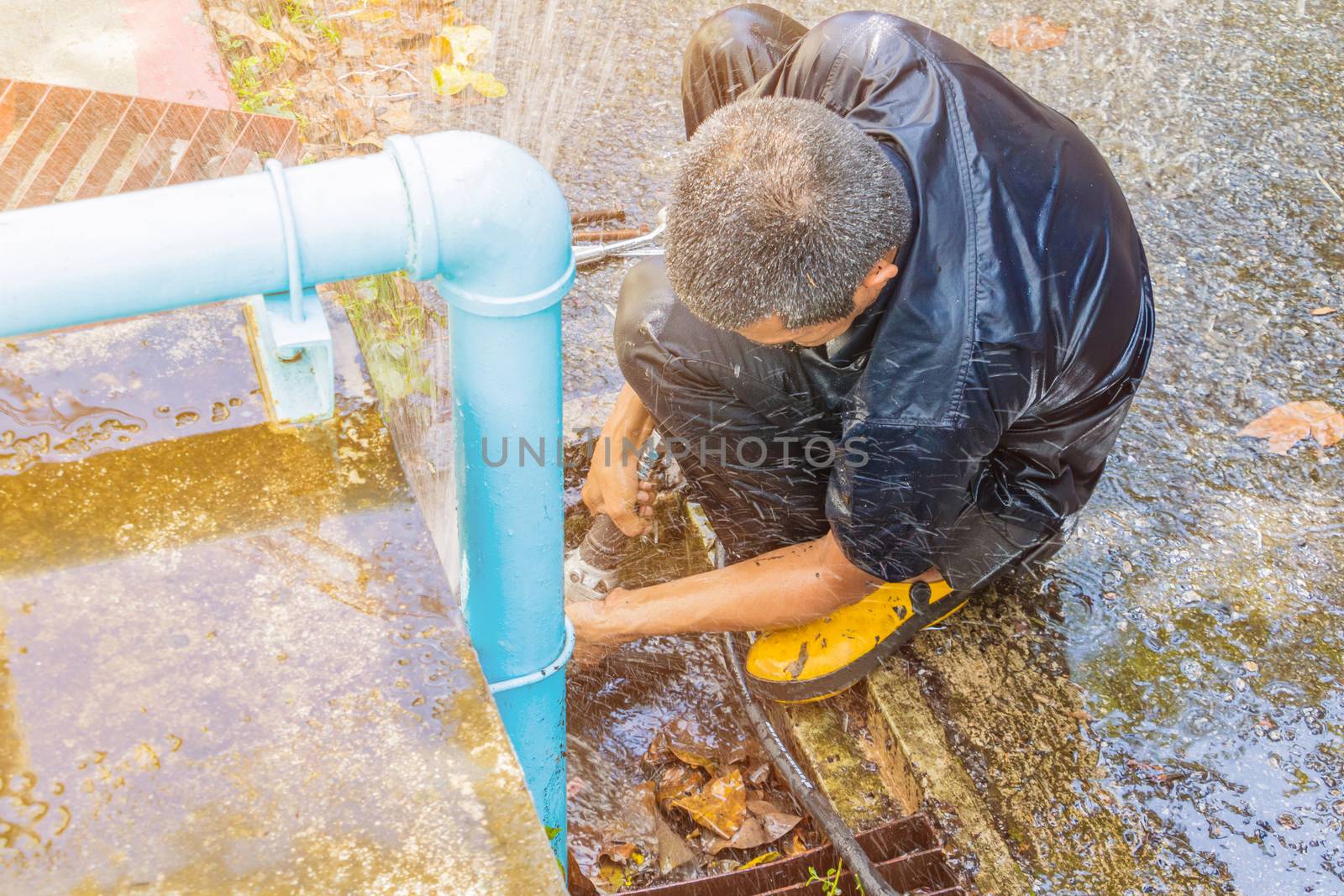plumber working repair the broken pipe and replace   in hole with water Motion at roadside
