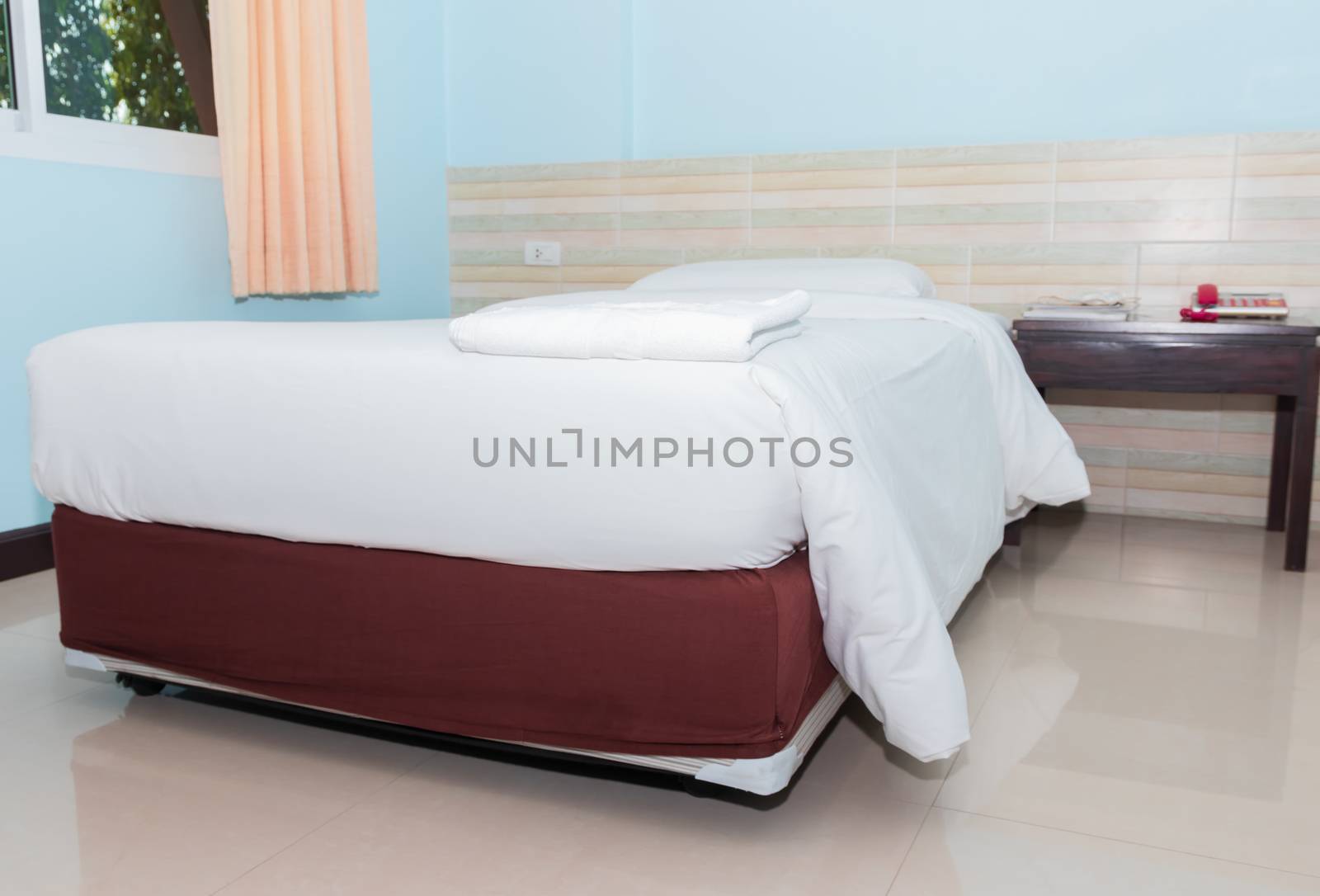 bed and  bedspread pillow white in in bedroom by pramot