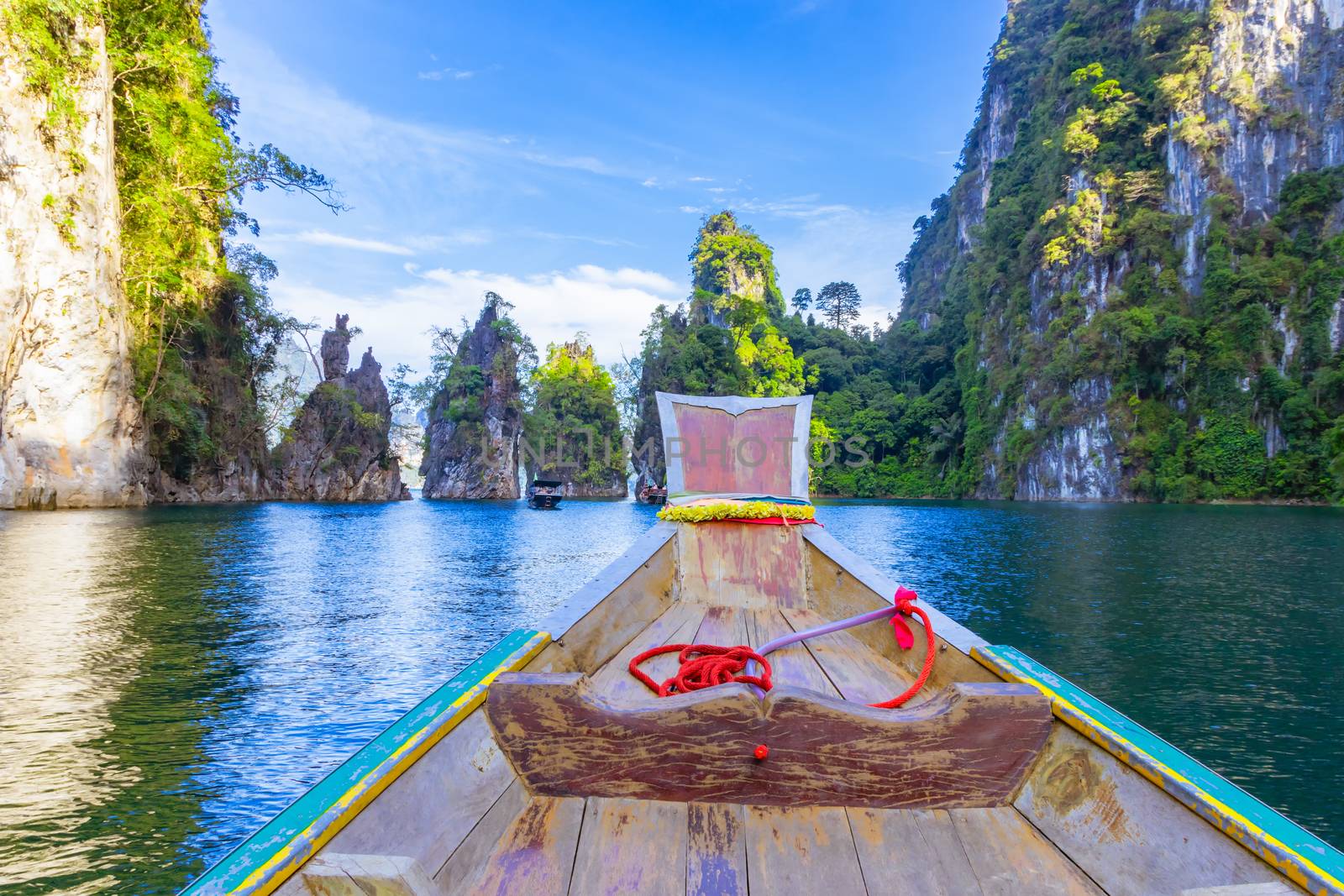 Wooden boat on sailing travel in Ratchaprapa Dam and Cheow Larn Lake, Khao Sok nature beautiful in Thailand