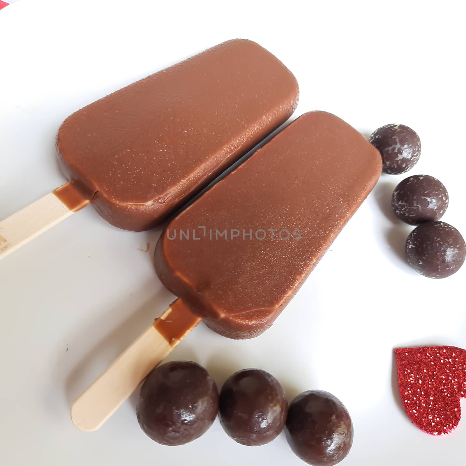 Delicious two chocolate icecream bar with chocolate ball in white plate plated beautifully by AnithaVikram