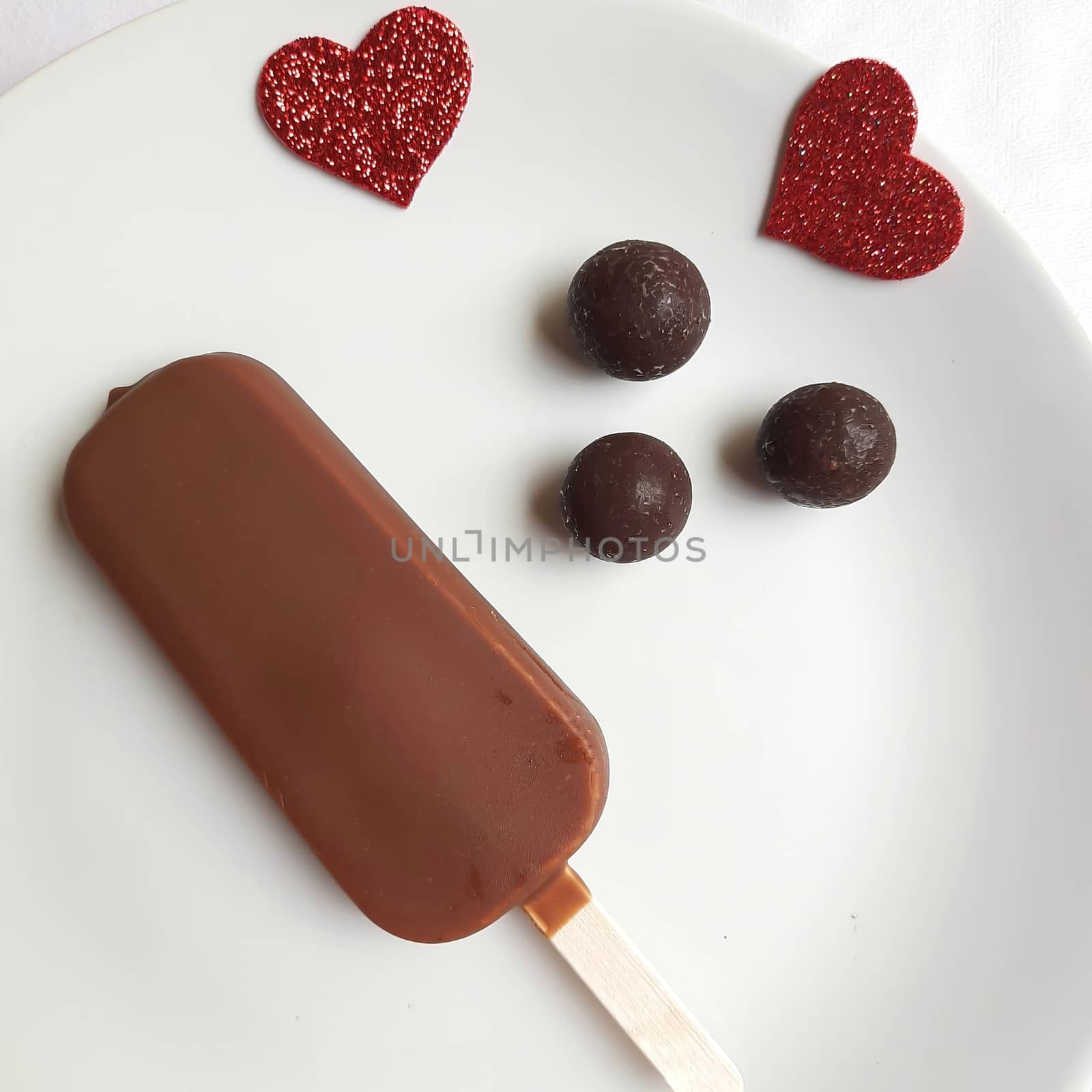 Delicious one chocolate icecream bar with chocolate ball in white plate plated beautifully by AnithaVikram