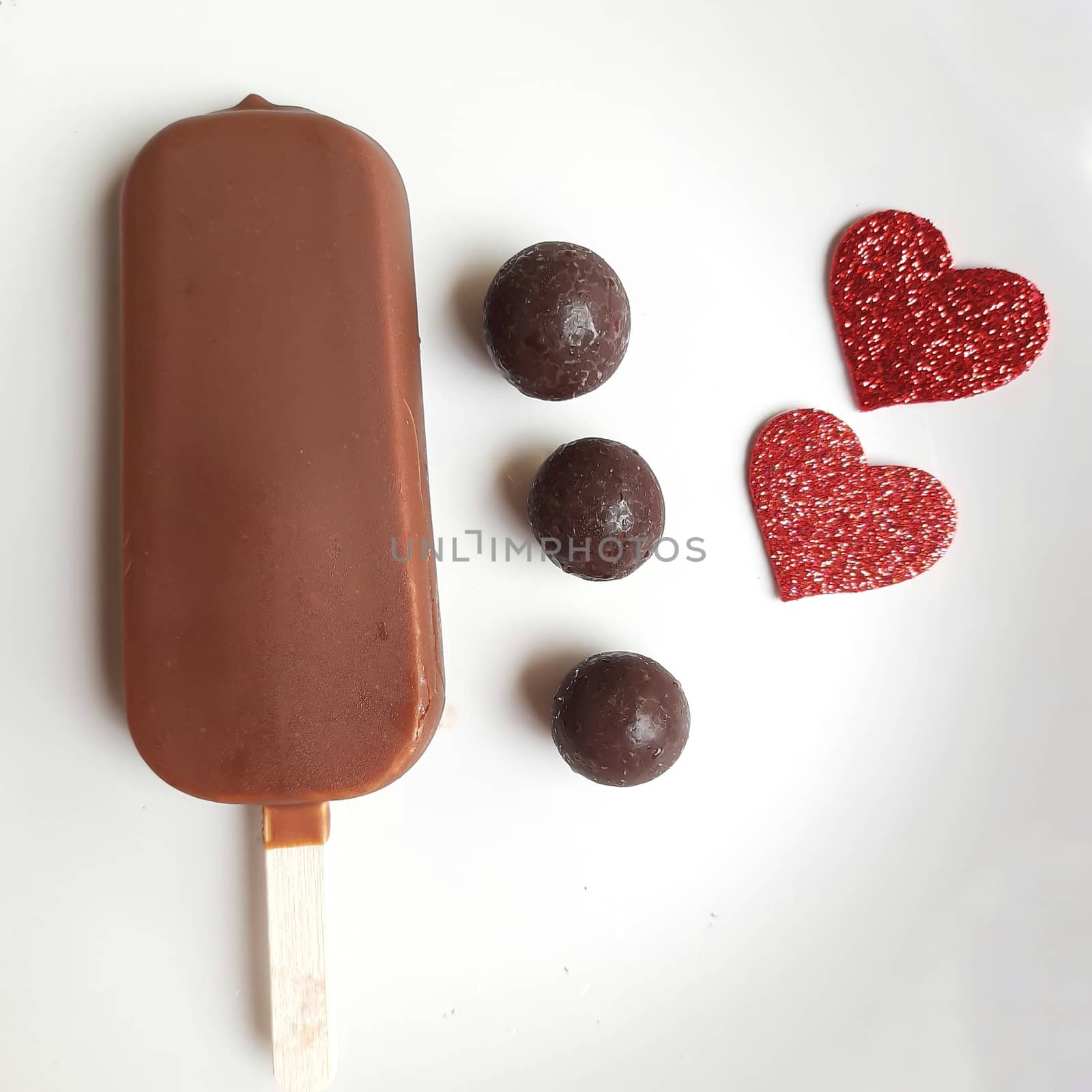 Delicious one chocolate icecream bar with chocolate ball in white plate plated beautifully by AnithaVikram