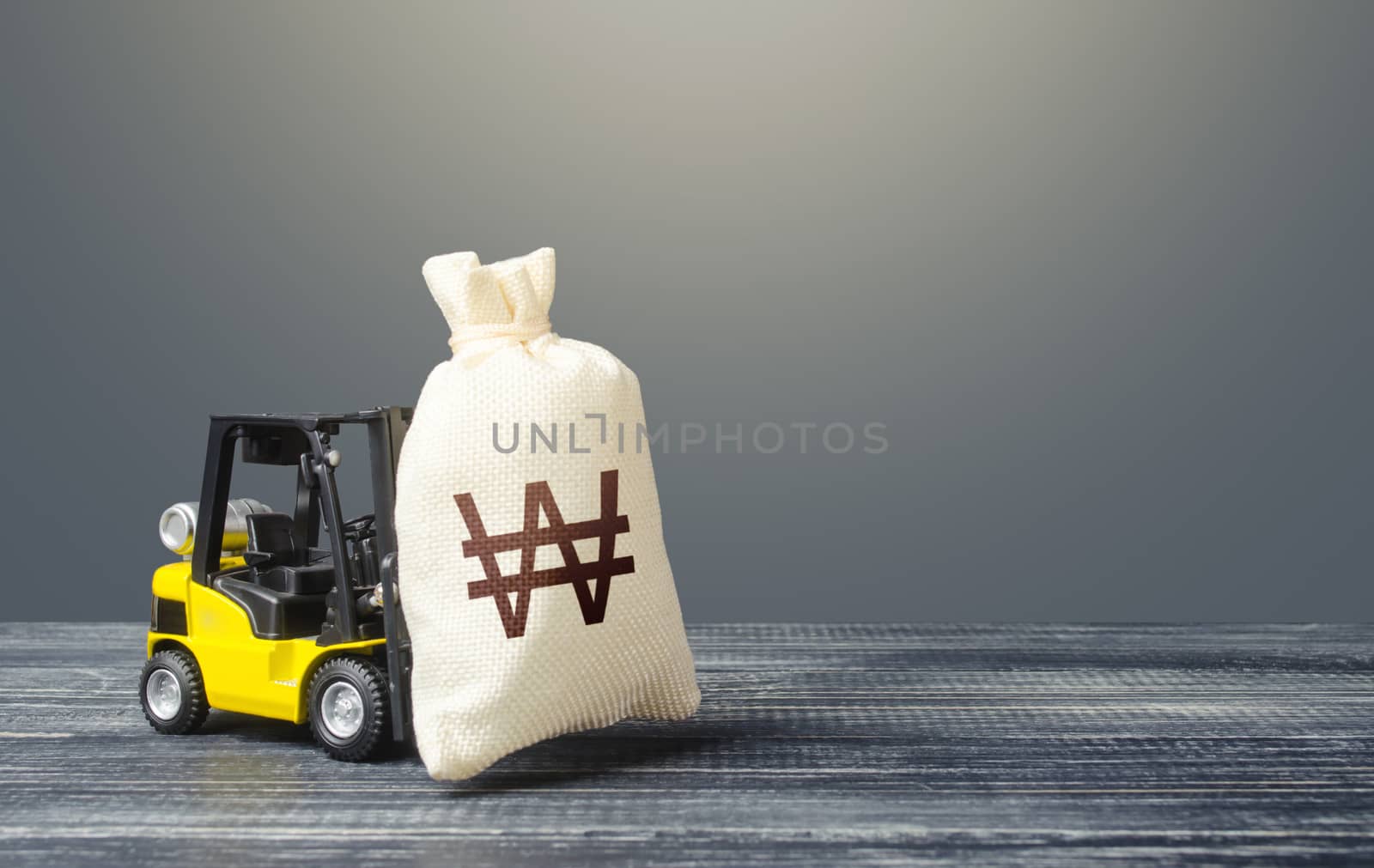 Forklift transports a south korean won money bag. Crisis recovery measures. Attraction of investments in business and economy, cheap loans, leasing. Borrowing on capital market. Stimulating economy.