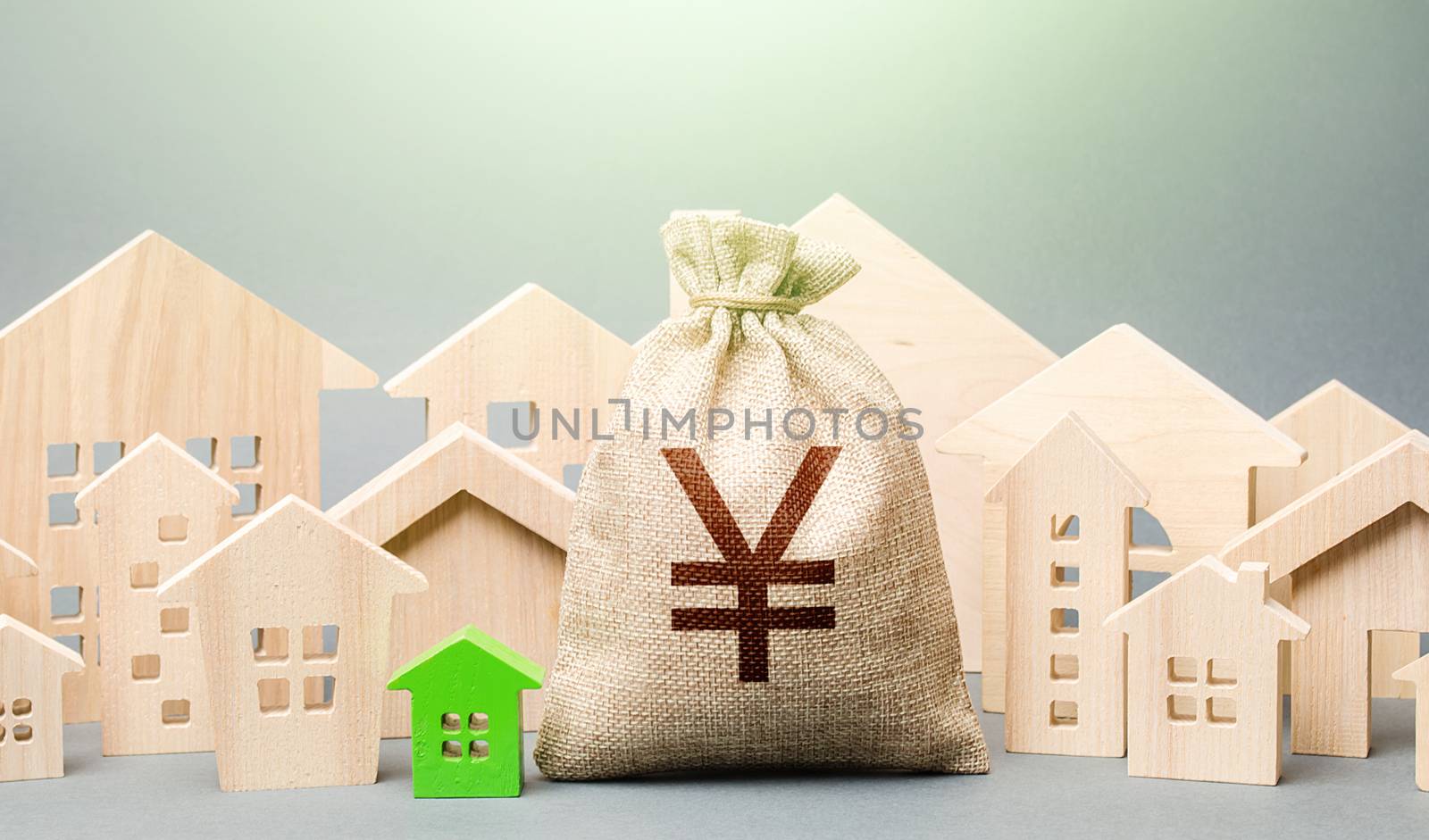 Yen Yuan money bag and a city of house figures. Buying real estate, fair price. City municipal budget. Development and renovation of buildings. Investments. Cost of living in town. Property tax.
