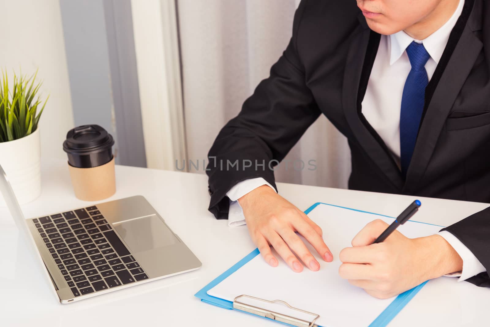 Businessman wearing suit video conference call laptop computer by Sorapop