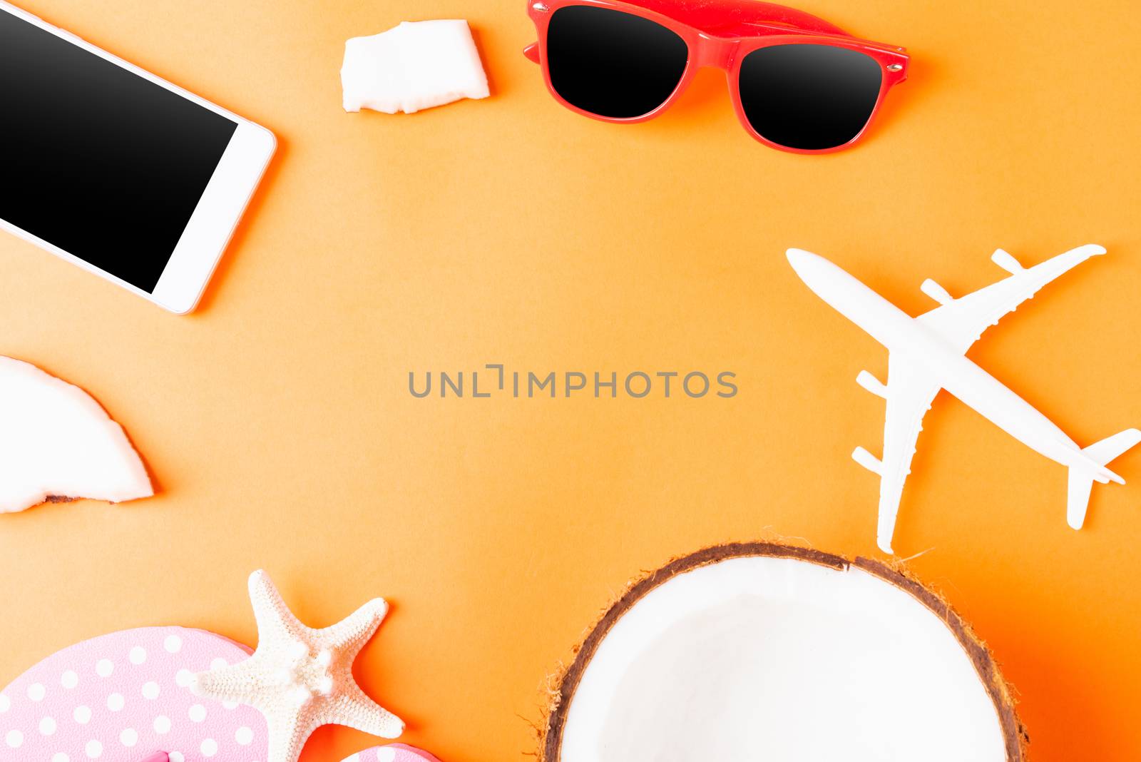 Happy coconuts day concept, fresh coconut, and summer accessories (model plane, sunglasses, smartphone, starfish and slippers), Beach tropical fruit trip journey and spring-summer holiday
