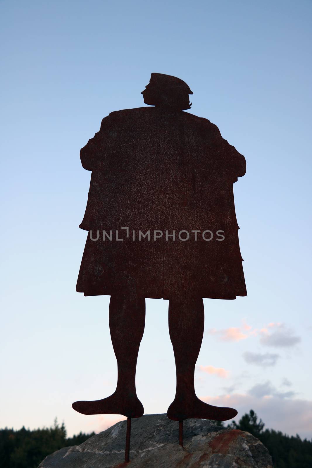 Iron silhouette of a man on a stone near the castle. by kip02kas