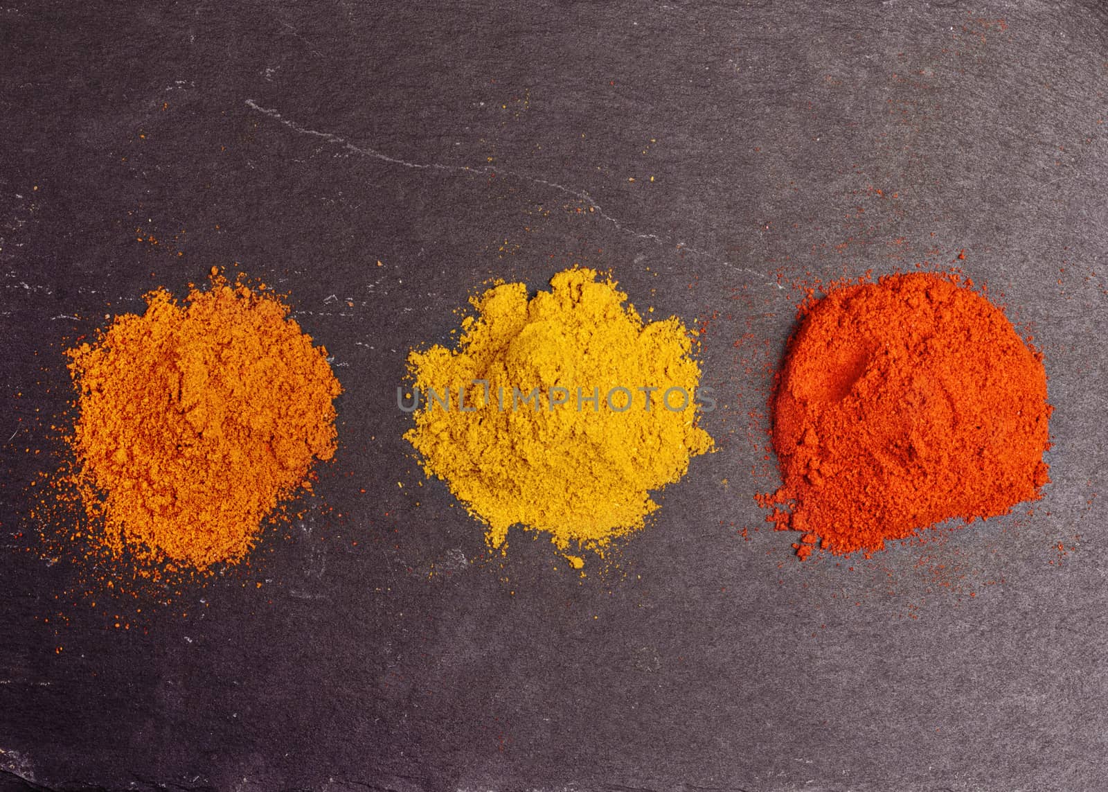 Colorful spices on black background