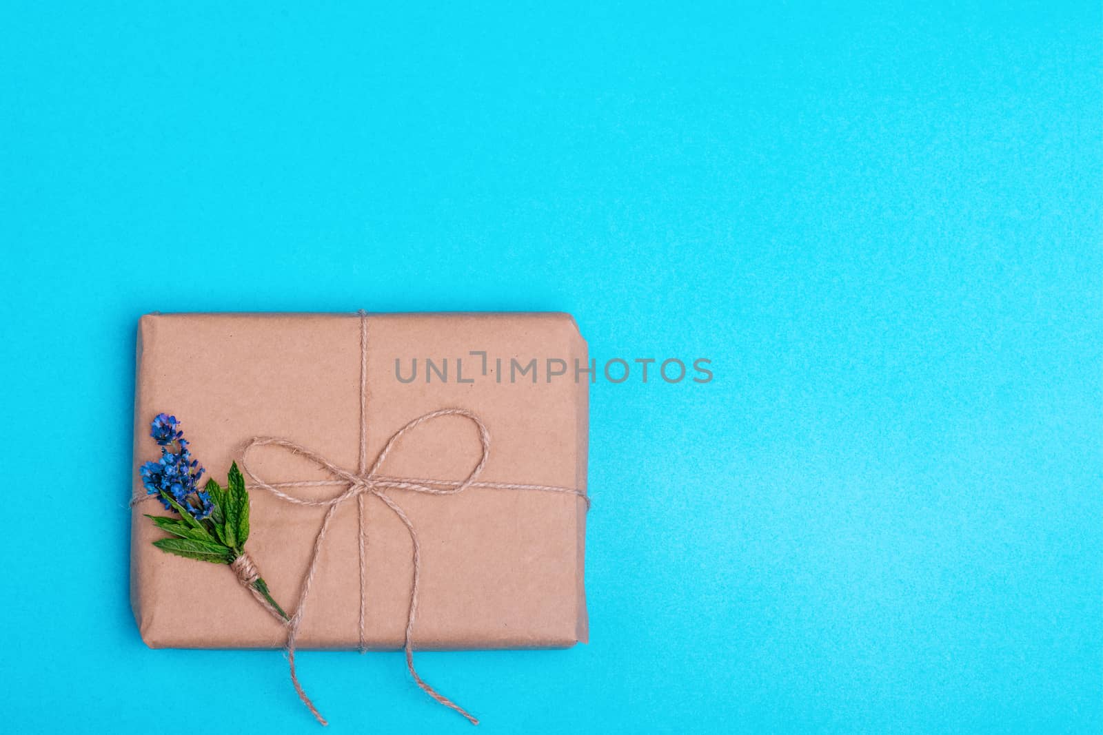 Gift box and a posy of lavender on blue background